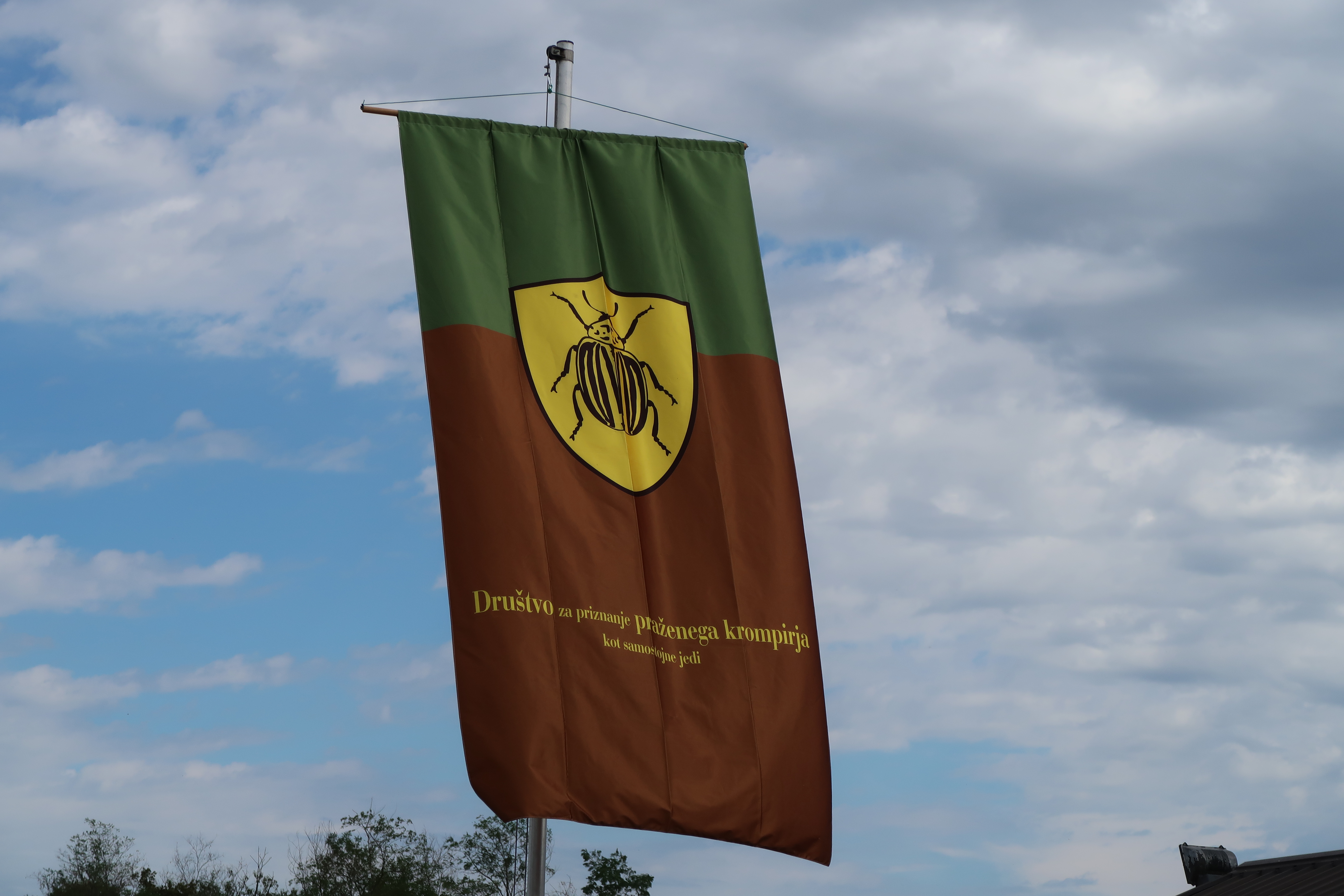 A flag featuring a potato bug represents the festival