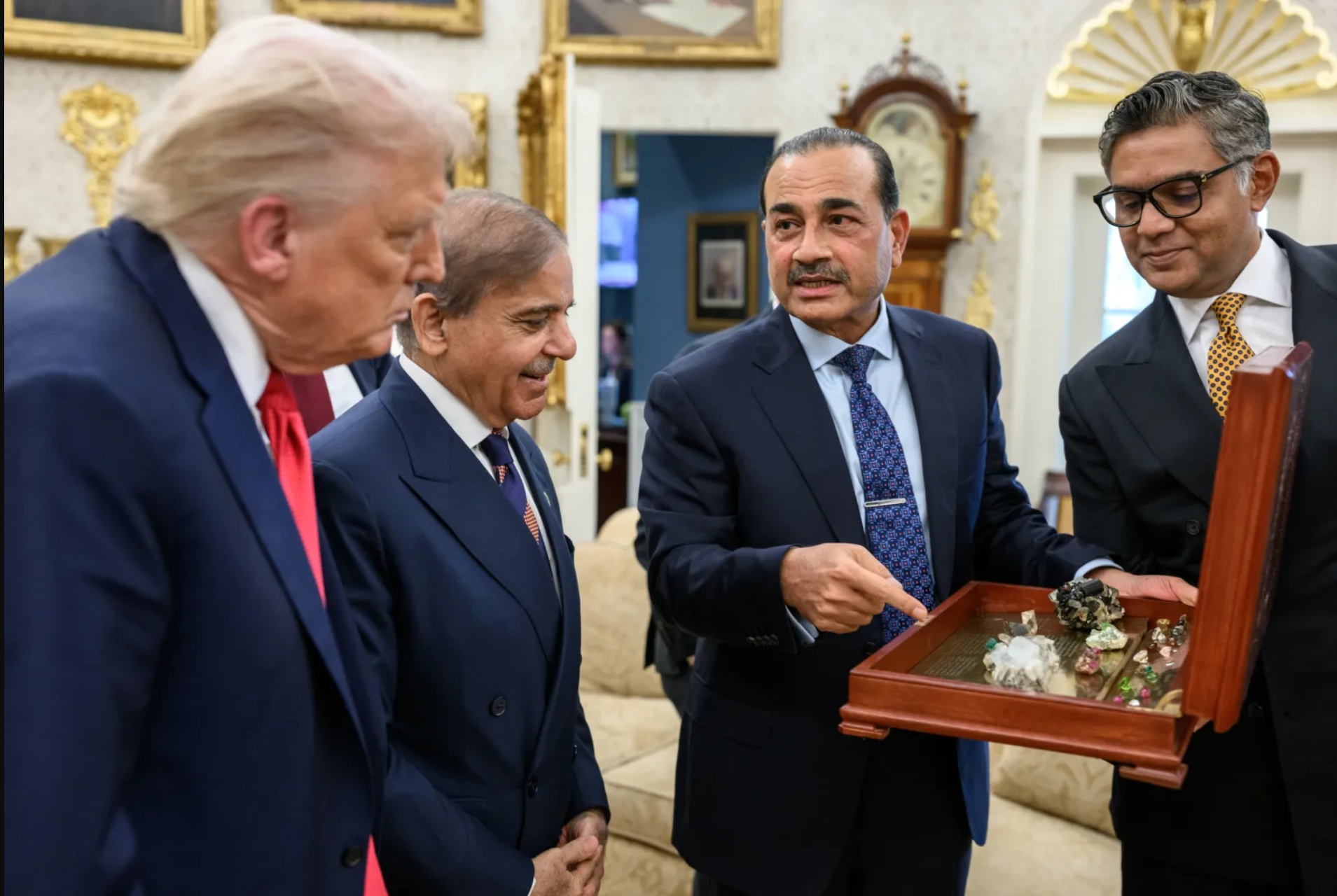 US President Donald Trump examines a box of rare-earth mineral and gemstone samples presented by Pakistan's Chief of Army Staff Field Marshal Asim Munir (center), alongside Pakistani Prime Minister Shehbaz Sharif (left) last year in September at the White House. [Courtesy White House]