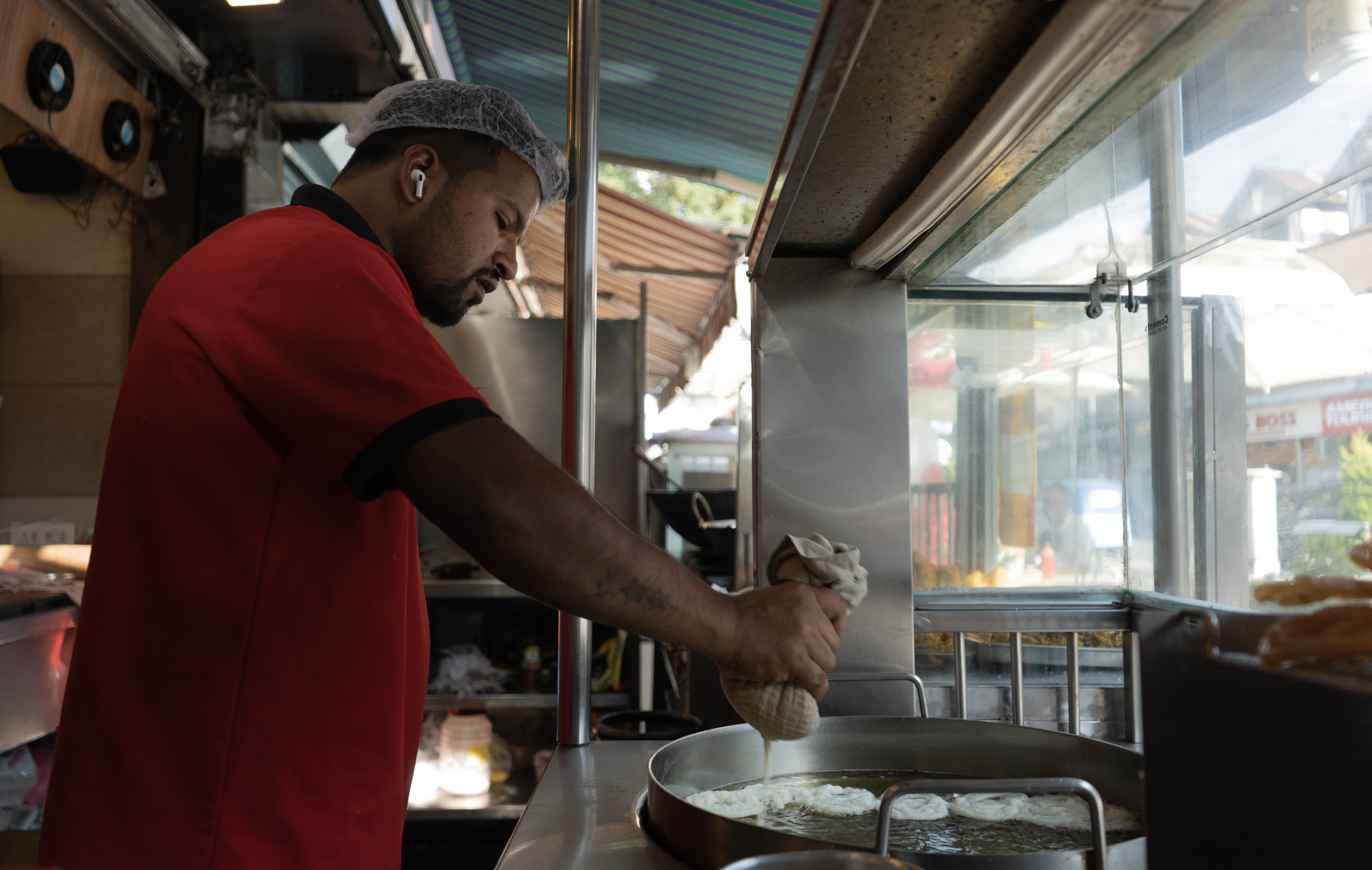 A worker at Modern Sweets, a popular sweet shop in Srinagar, the summer capital of Indian-administered Kashmir, prepares jalebi, a traditional Indian sweet made with flour, yogurt, clarified butter and granulated sugar. (Picture by Wasim Nabi for Al Jazeera)
