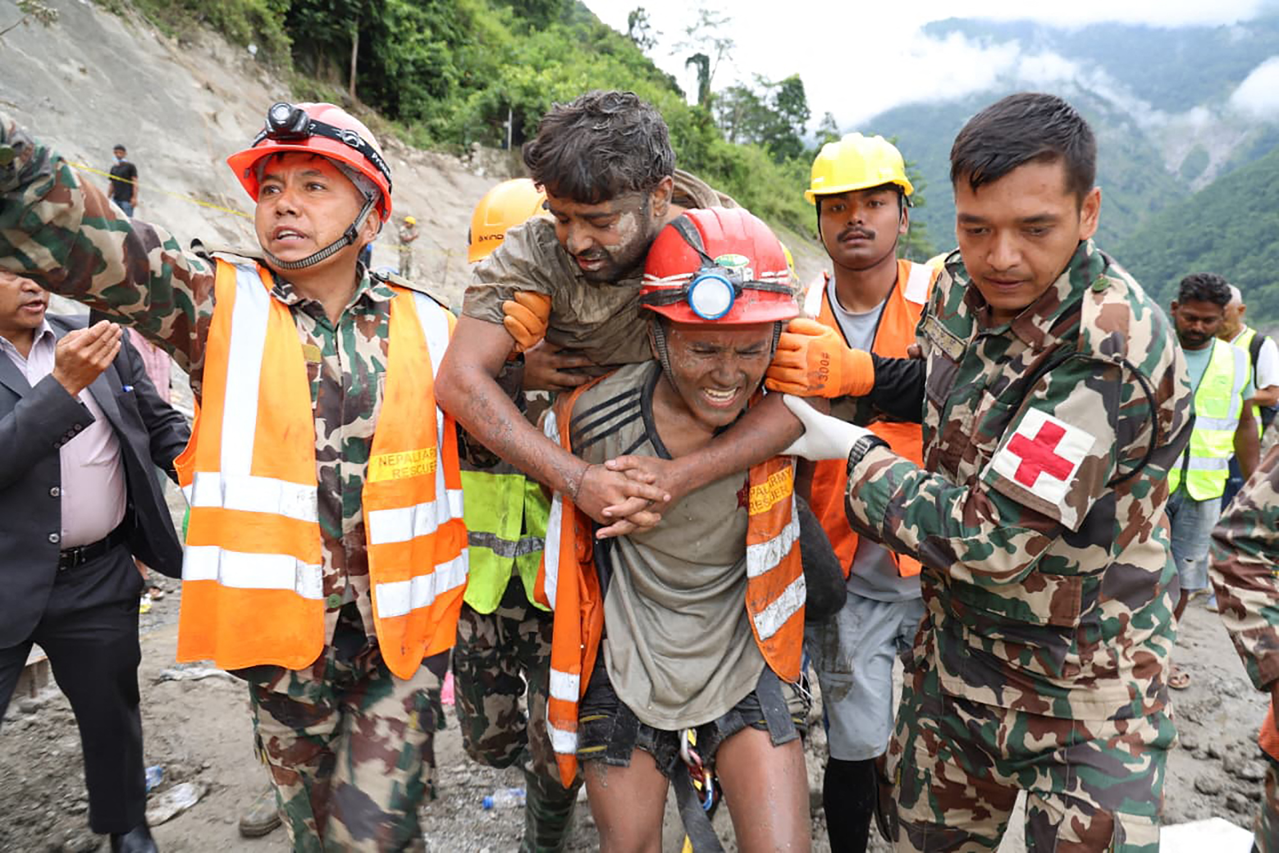 Army personnel carrying a worker.