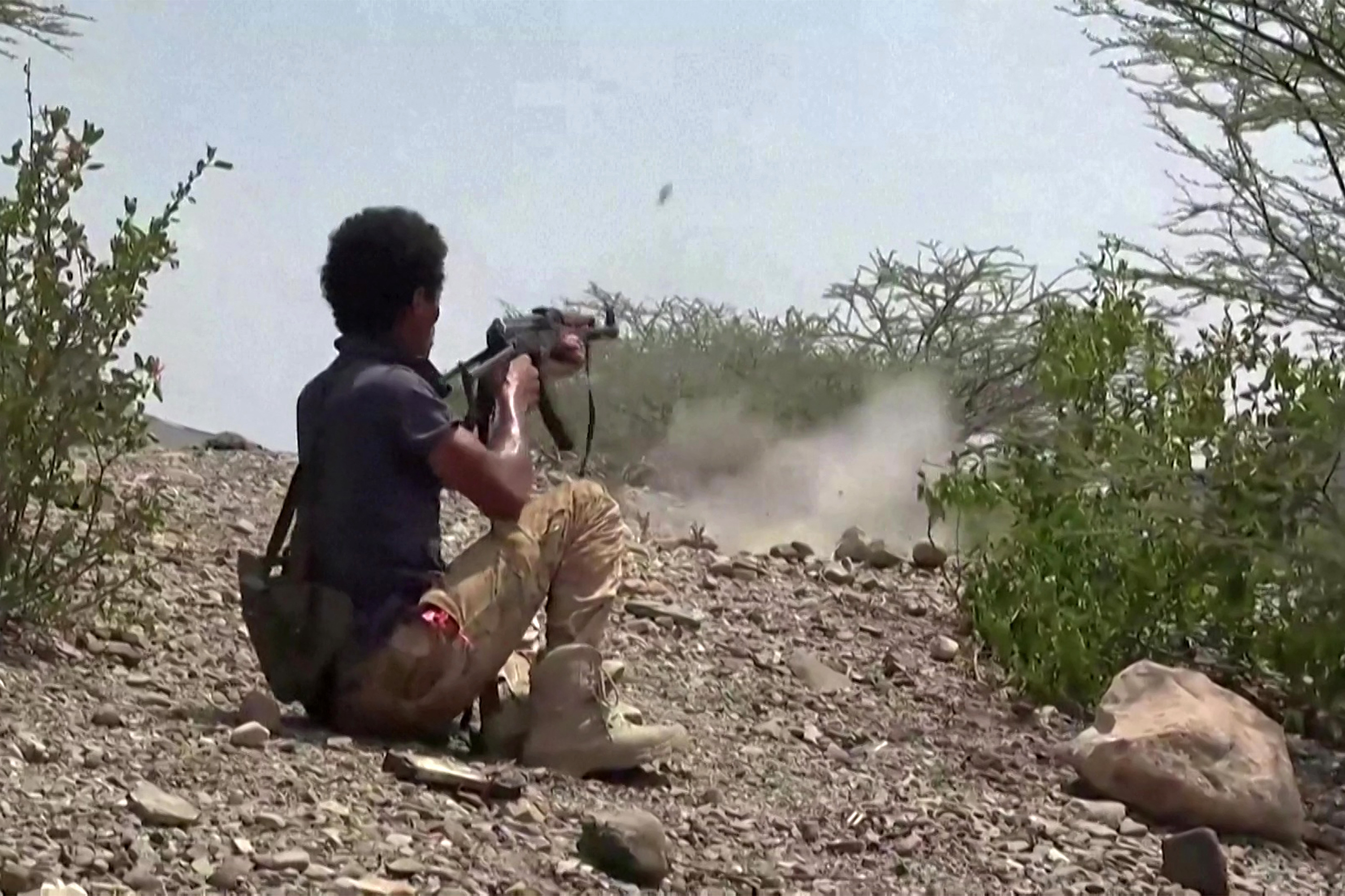 TOPSHOT - This screen grab taken from video footage released on September 8, 2026 by the Saudi-backed National Resistance Forces in Yemen shows a fighter firing an assault rifle, as Yemeni government forces and National Resistance Forces fire at Houthi fighters on the Kadha front, west of the city of Taiz in Yemen's western Taiz province.