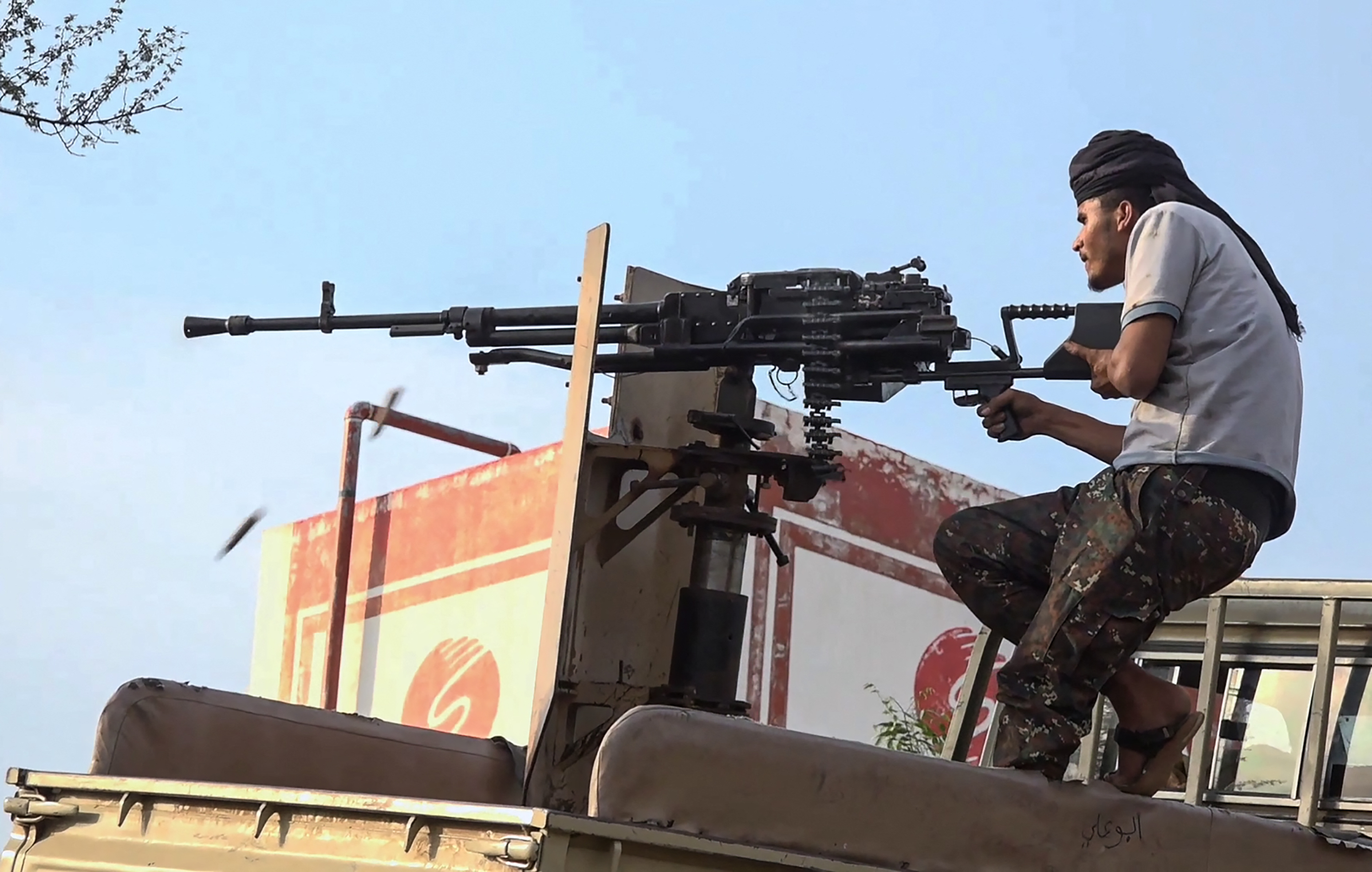 TOPSHOT - This frame grab taken from AFPTV video footage on September 9, 2026, shows a member of the Saudi-backed Yemeni government forces firing a heavy machine gun during clashes with Houthi fighters in the Al-Kadha area, west of Taiz province, on September 8, 2026.