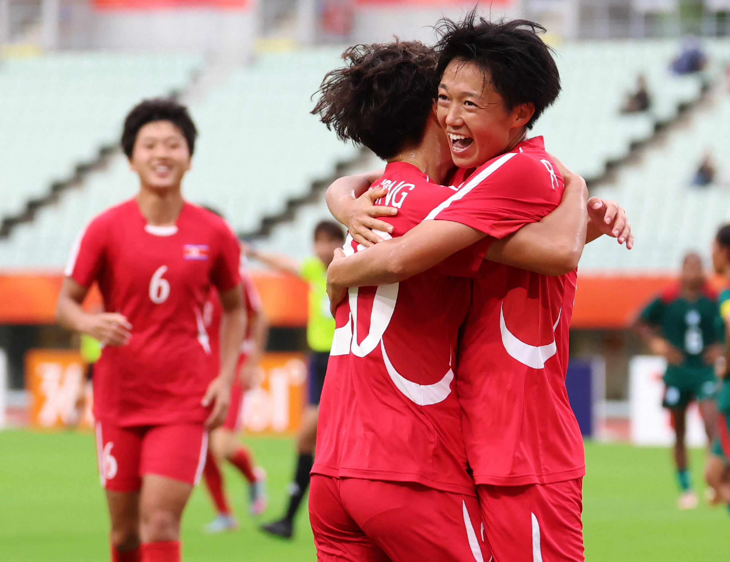 North Korea’s Ri Song-a, right, celebrates after scoring during the 2026 Asian Games women’s football match against Bangladesh at Yanmar Stadium Nagai in Osaka on September 14, 2026 [AFP]