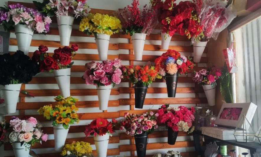 Artificial flowers sit on display in a Gaza flower shop. Due to scarcity and high prices for natural flowers amid the war, these bouquets are often rented for just a few hours for weddings today [Alaa Dmeida/AP]