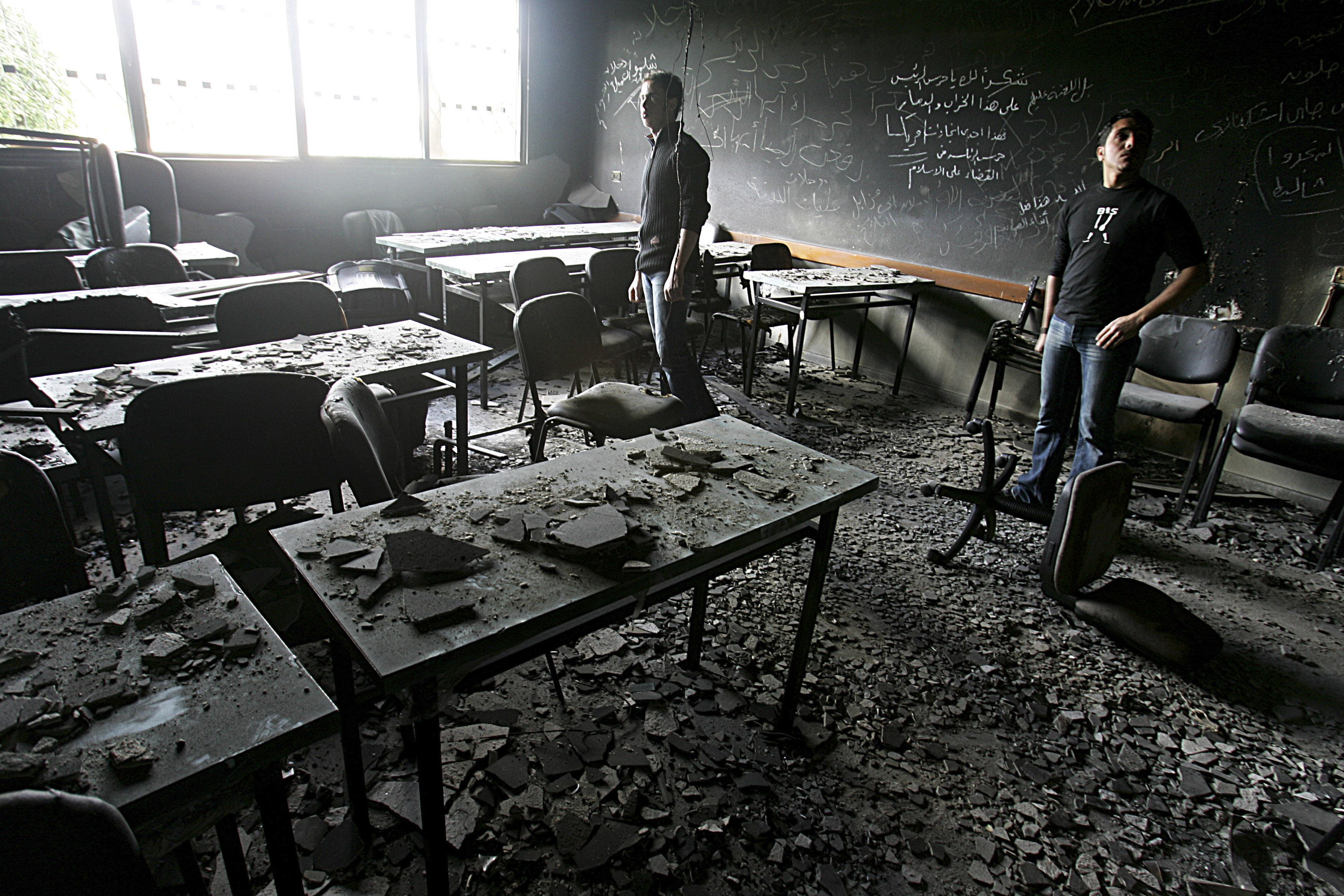 GAZA CITY, GAZA STRIP - FEBRUARY 6: Palestinian students and visitors inspect the damaged and burnt laboratories and classrooms of The Islamic University, a scientific stronghold of Hamas February 6, 2007 in Gaza City, Gaza Strip. The Islamic University was attacked by the guards of Palestinian President Mahmud Abbas this past week during clashes between Fatah and Hamas. Hamas fighter, Mohammad Abu Karsh was killed during a Fetah attack while three others were wounded by gunmen later in the week. Palestinian President Mahmoud Abbas and Hamas Prime Minister Ismail Haniyeh traveled to Mecca for talks to stop the Palestinian factional conflict. (Photo by Abid Katib/Getty Images)