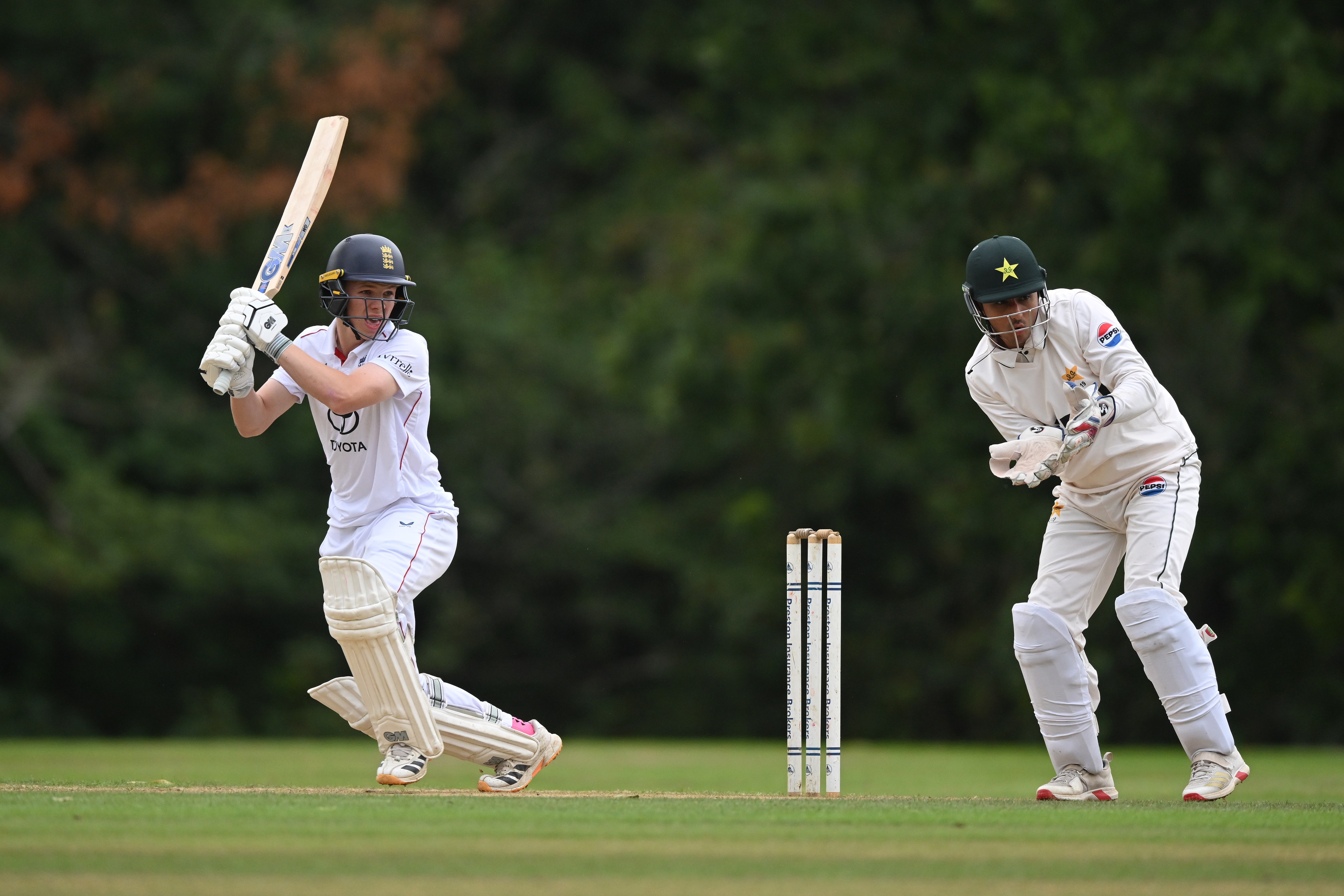 ARUNDEL, ENGLAND - SEPTEMBER 02: Joe Moores of England U19 hits out as wicketkeeper Hamza Zahoor of Pakistan U19 looks on during day 1 of the U19 Test match between England and Pakistan at Arundel Castle Cricket Club Ground on September 02, 2026 in Arundel, England. (Photo by Mike Hewitt/Getty Images)