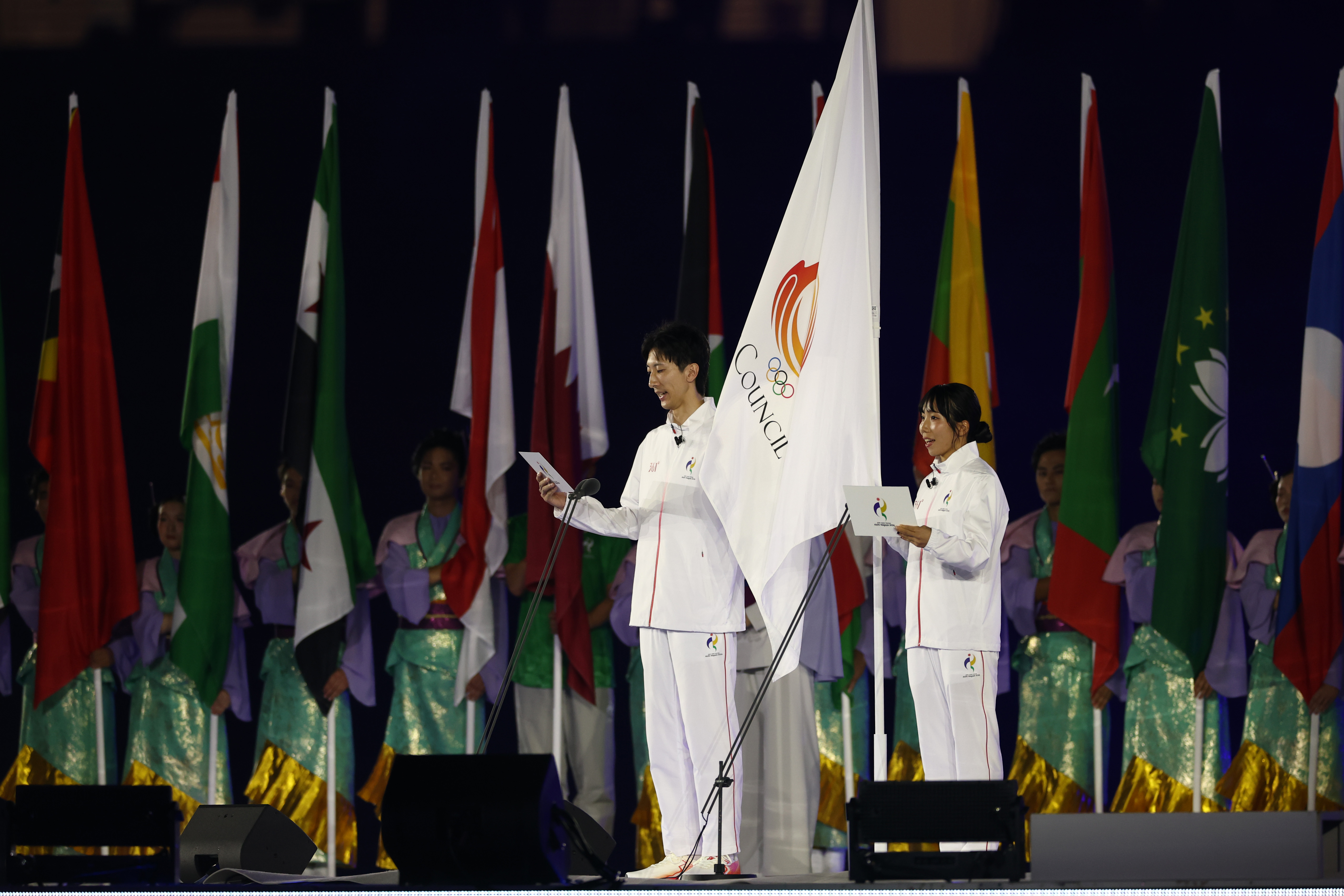 NAGOYA, JAPAN - SEPTEMBER 19: Yuri Tanaka and Ryoichi Akamatsu of Japan takes the athletes' oath during the opening ceremony on day zero of the 20th Asian Games Aichi-Nagoya at Nagoya City Mizuho Park Athletic Stadium on September 19, 2026 in Nagoya, Aichi, Japan. (Photo by Yong Teck Lim/Getty Images)