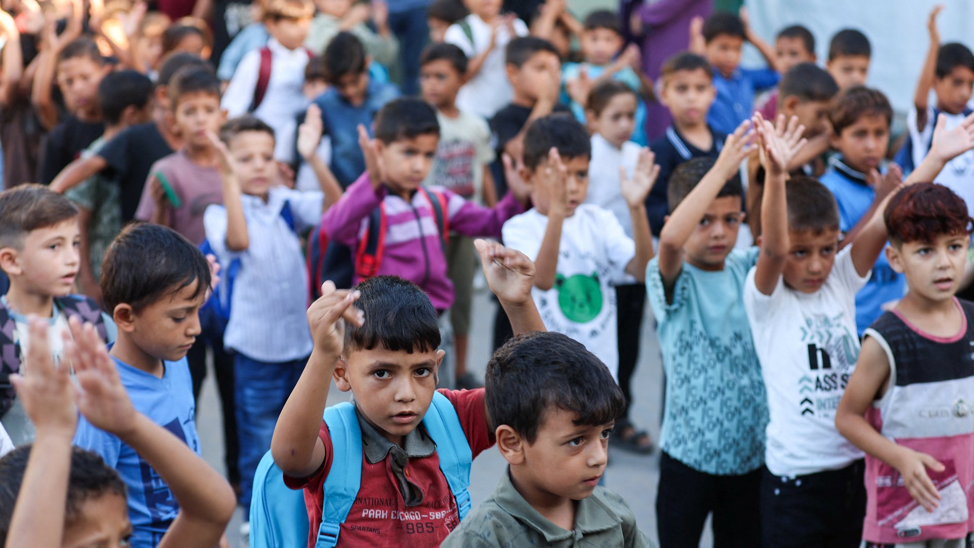 Children in Gaza wearing backpacks in school