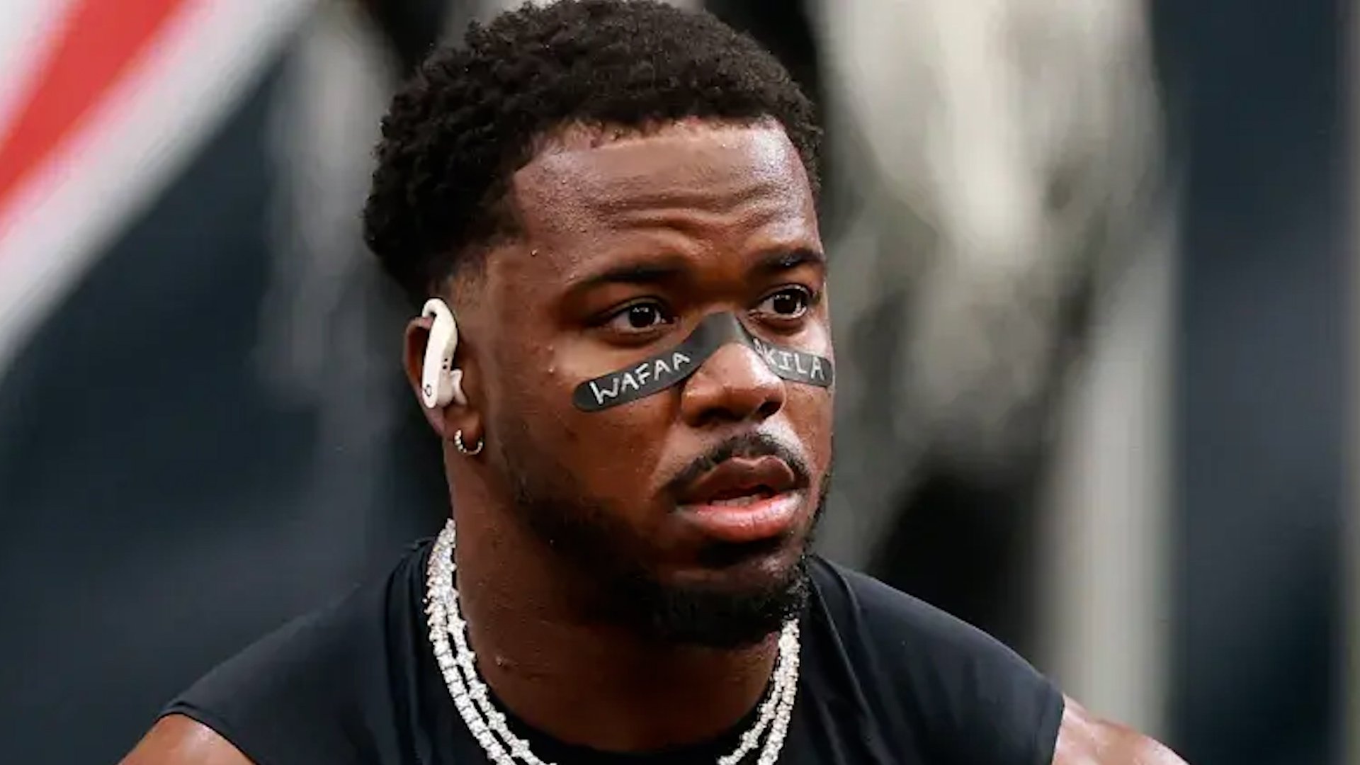 NFL Player Azeez Al-Shaair displaying Wafaa Akila's name on his eye-black.