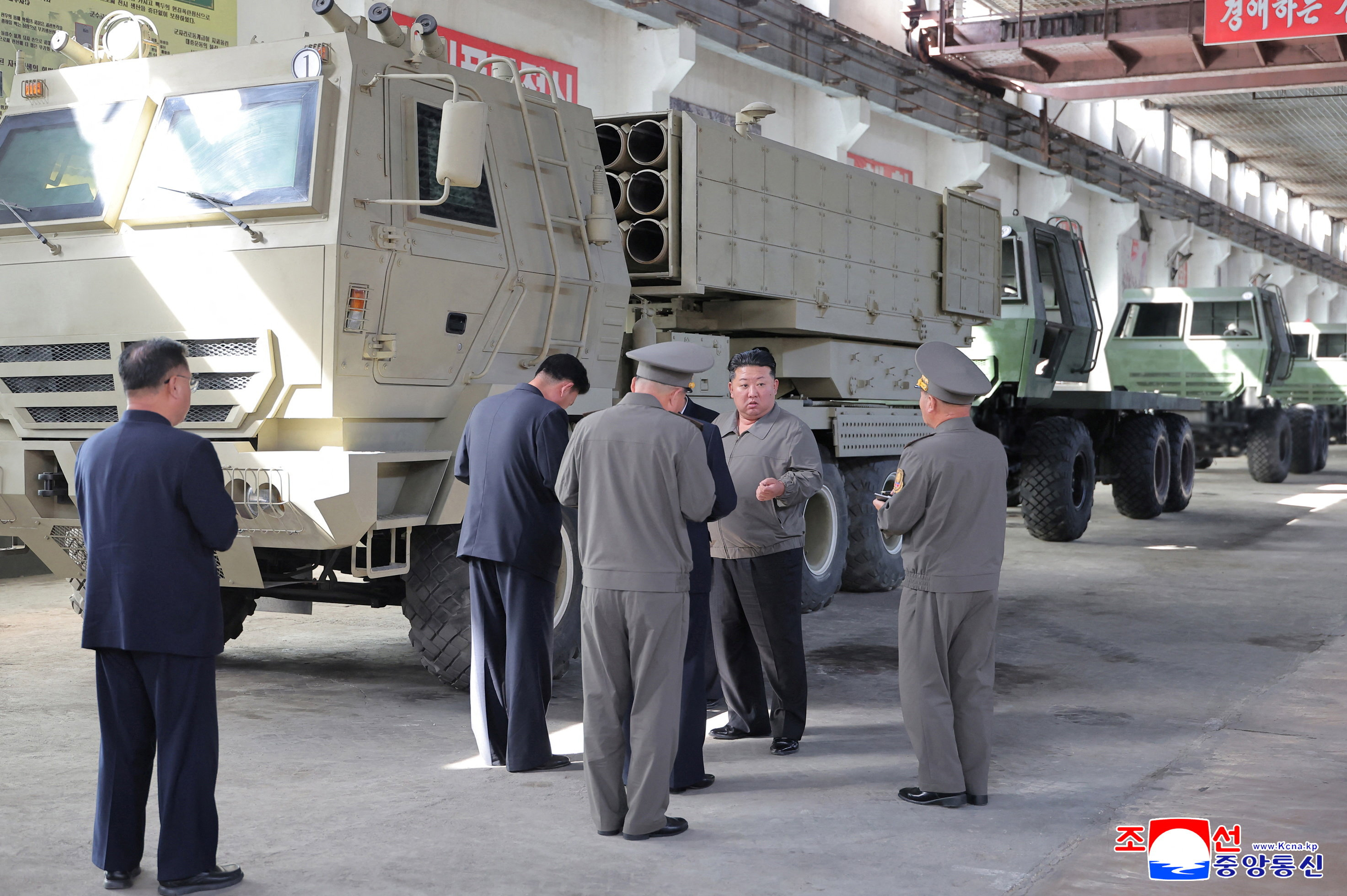 Kim Jong Un views machinery at an industrial facility.
