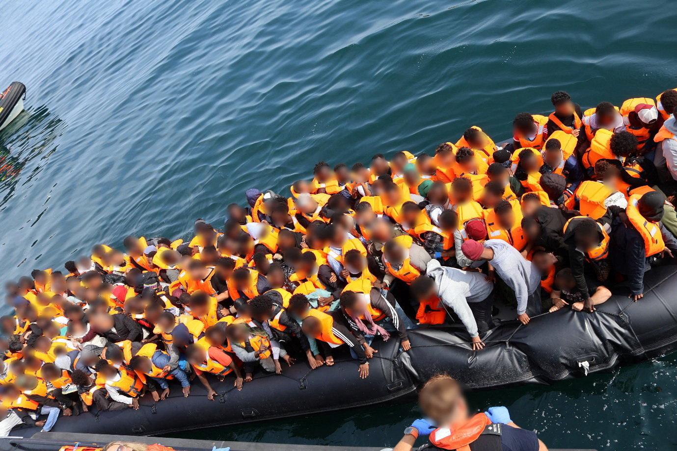 Migrants are seen on board a boat, which was operated by Chan Mathok Atak, during the crossing of the English Channel on July 23, 2026