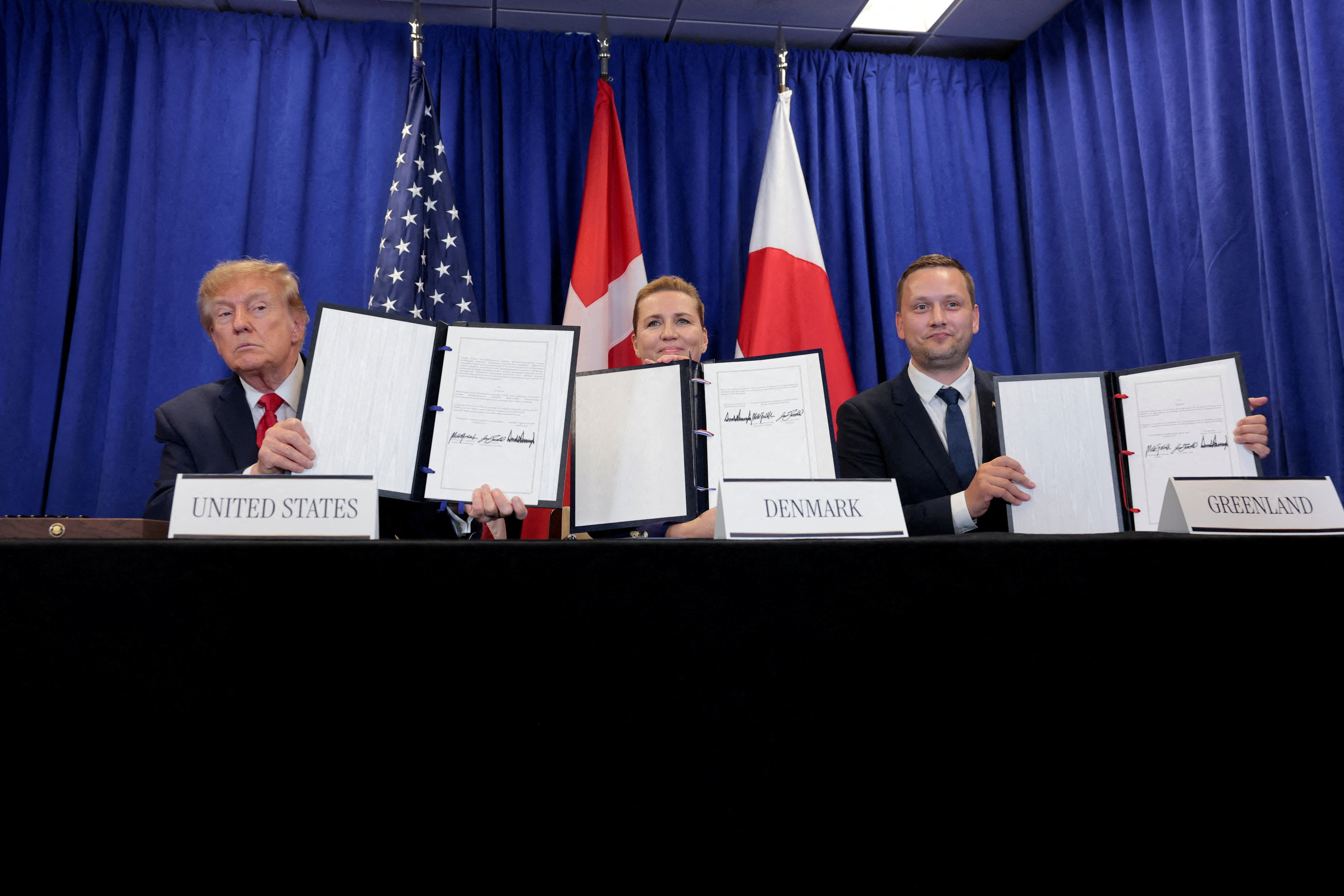 US President Donald Trump, Danish Prime Minister Mette Frederiksen and Greenland Prime Minister Jens-Frederik Nielsen show signed documents during a trilateral signing event regarding a deal on Greenland's security, during the 81st United Nations General Assembly (UNGA), in New York City, US, September 22, 2026. REUTERS/Kylie Cooper TPX IMAGES OF THE DAY