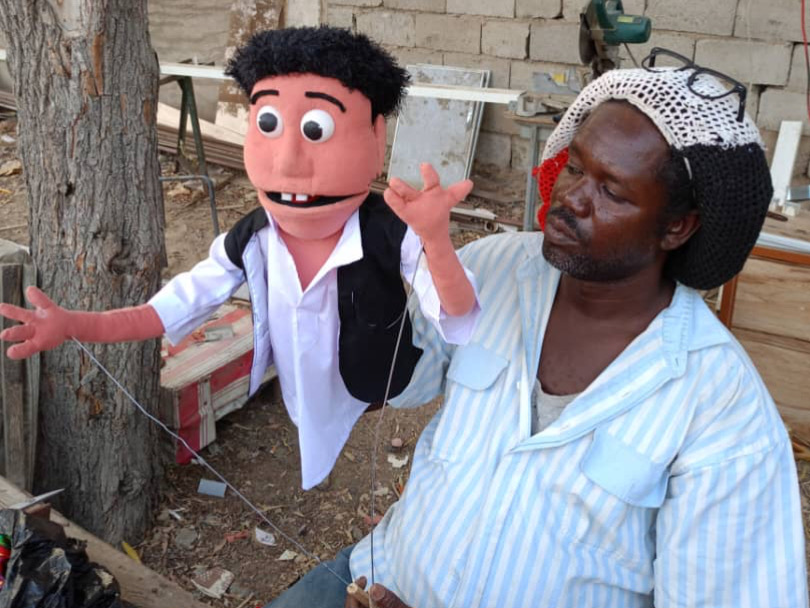 A man holds a puppet.