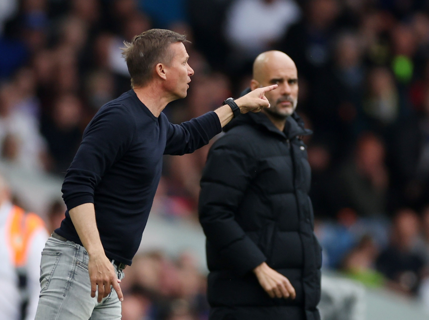 Leeds United manager Jesse Marsch reacts as Manchester City manager Pep Guardiola looks on during a Premier League match