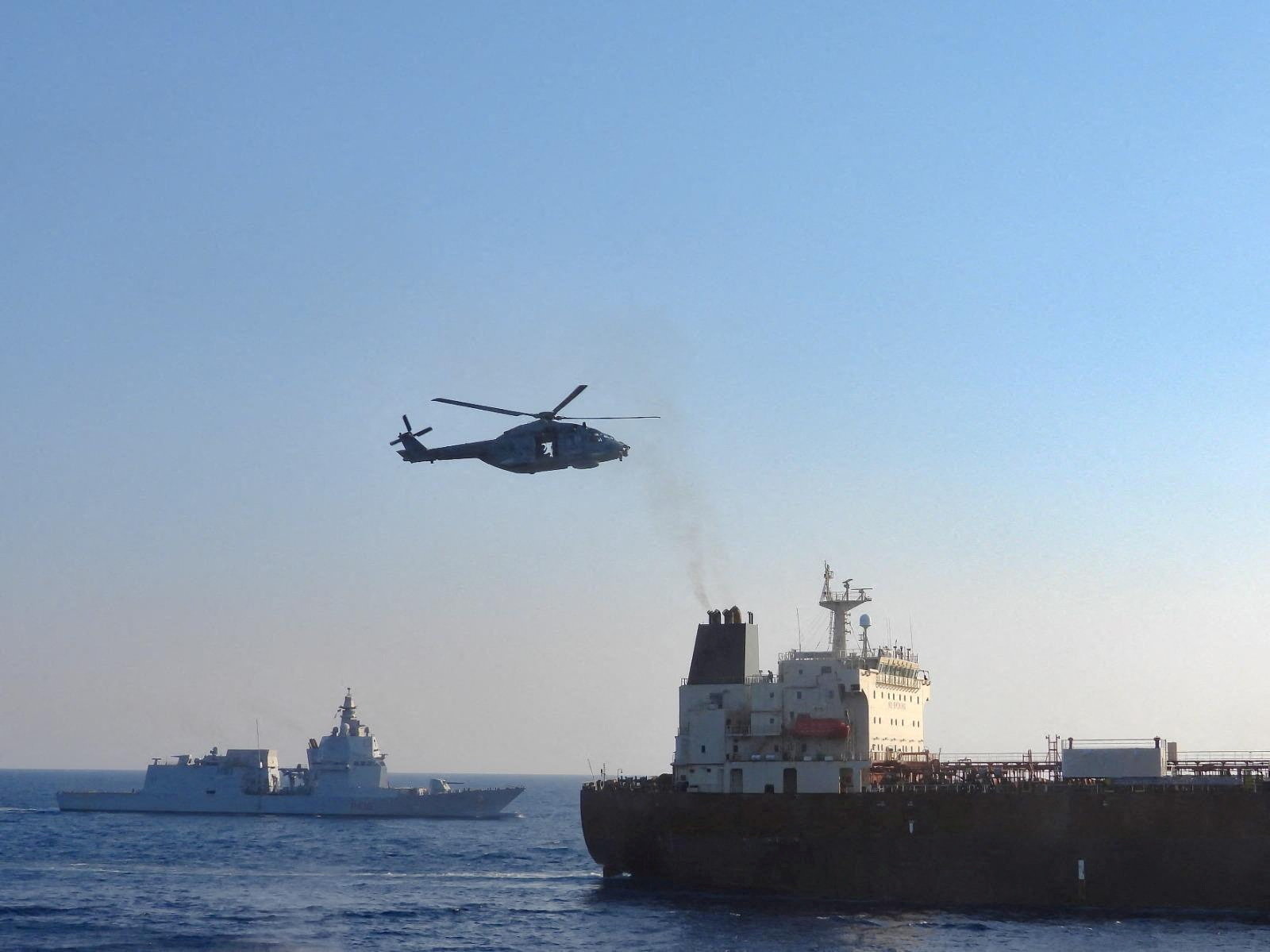 An Italian military helicopter flies above the oil tanker Toa Payoh, foreground, as the Italian Navy ship Thaon di Revel sails nearby during an inspection by the European Union’s EUNAVFOR MED IRINI mission in international waters west of the Italian island of Pantelleria, August 2, 2026. The Italian Defence Ministry said the EU-sanctioned tanker declared it was sailing under a Cameroon flag and described it as part of Russia’s so-called “shadow fleet”. Italian Defence Ministry/Handout via REUTERS. ATTENTION EDITORS – THIS IMAGE HAS BEEN SUPPLIED BY A THIRD PARTY. MANDATORY CREDIT. BEST QUALITY AVAILABLE. MANDATORY CREDIT