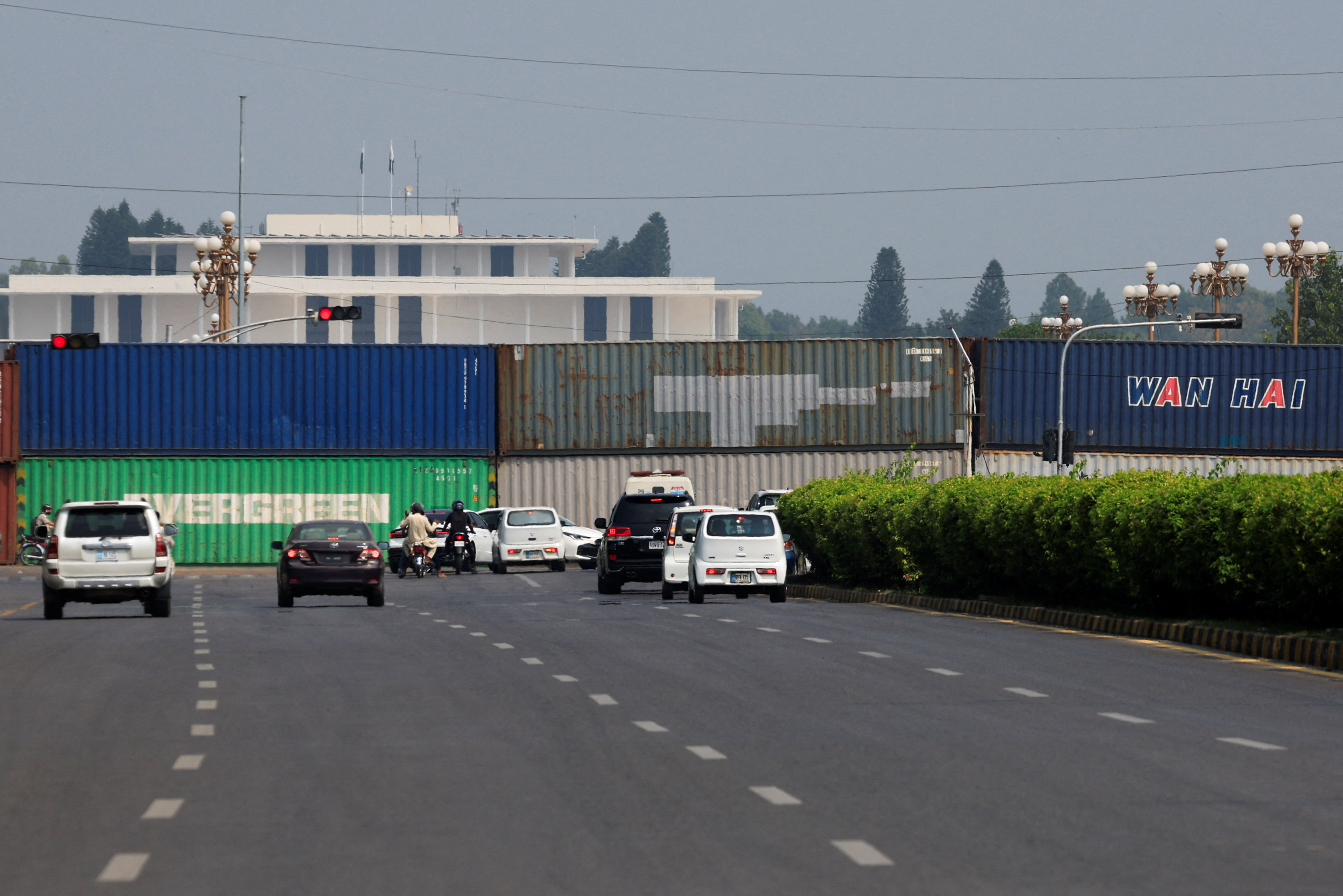 Shipping containers are used to block the road leading to the Aiwan-e-Sadr (Presidential Palace) ahead of a planned march by former Pakistani Prime Minister Imran Khan's party, demanding his release and calling for the supremacy of the Constitution and restoration of the rule of law across the country, in Islamabad, Pakistan, September 24, 2026. REUTERS/Akhtar Soomro