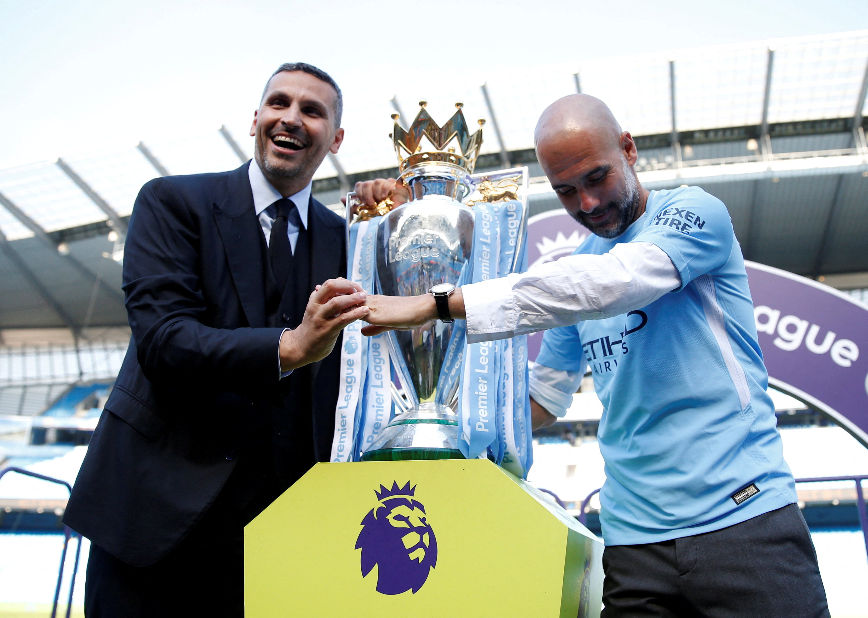 Manchester City manager Pep Guardiola and chairman Khaldoon Al Mubarak celebrate with the trophy after winning the Premier League title