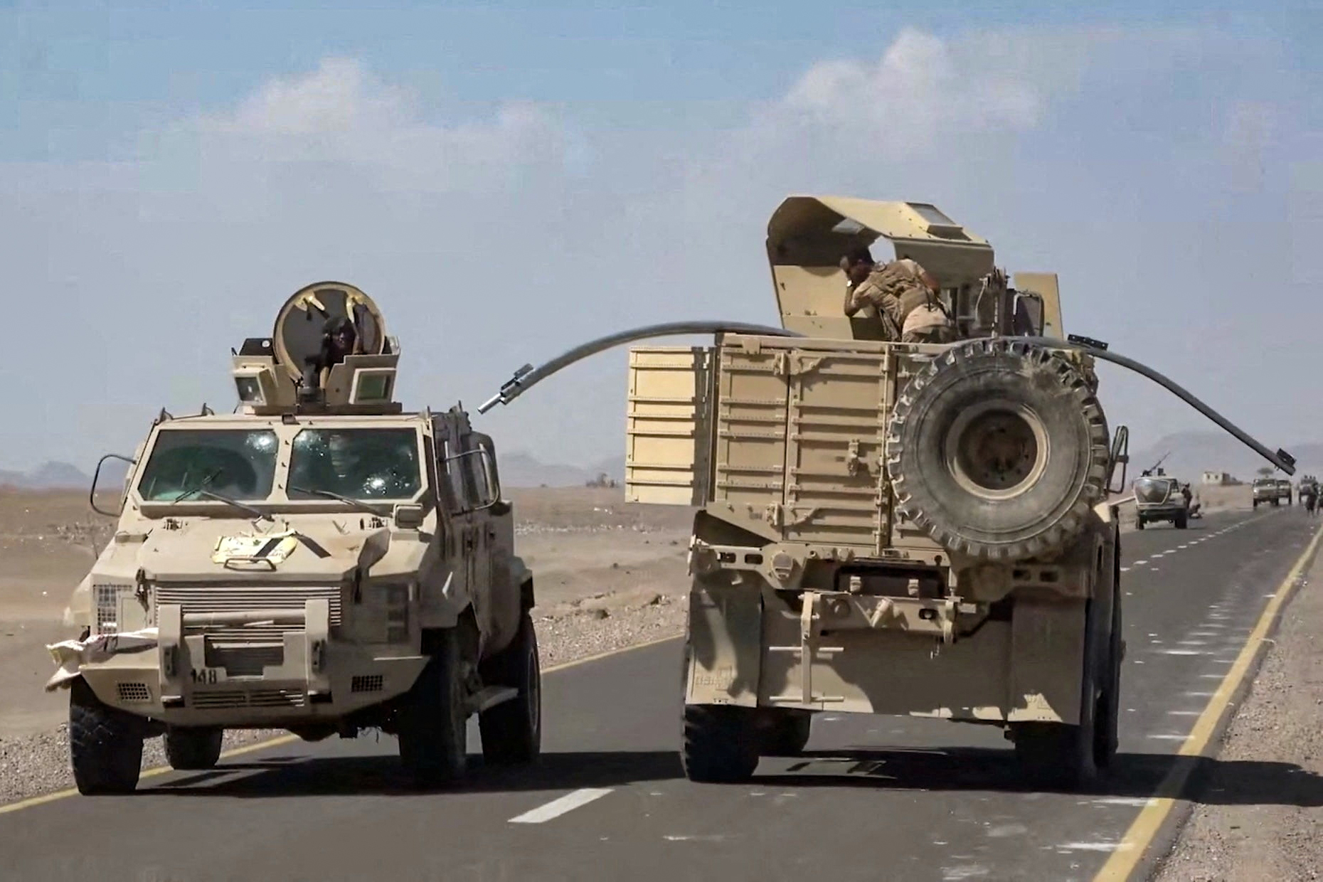 Military vehicles travel along a road during what Saudi-backed Yemeni government forces say was an advance against the Iran-backed Houthis, near Dhubab, Taiz Governorate, Yemen, in this still image taken from video released October 5, 2026.