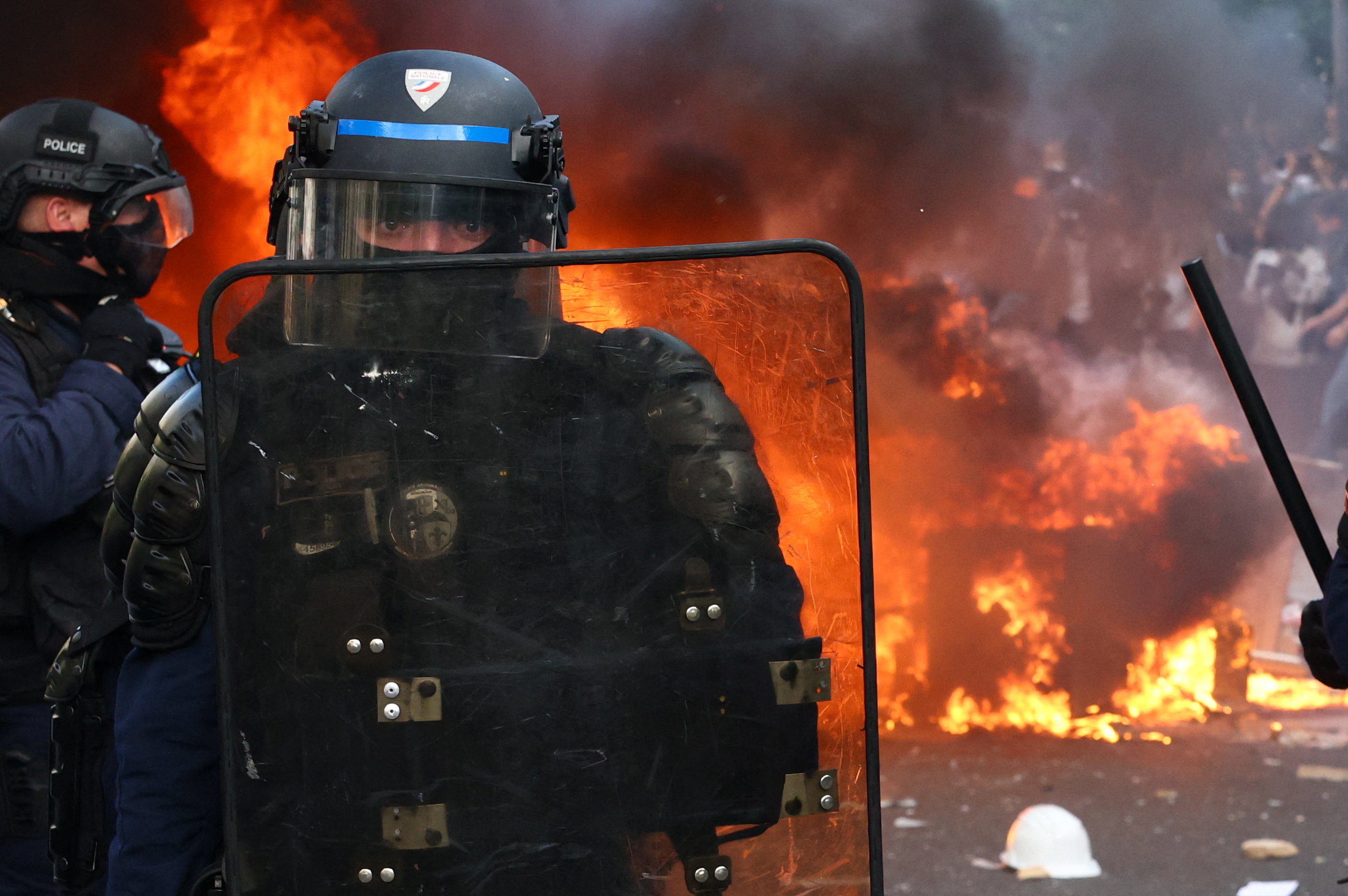 French CRS riot police stand in position near objects set on fire amid clashes with protesters during a demonstration by high school and university students, supported by teachers' union and school parents, in Paris as part of a nationwide day of demonstrations and blockades, voicing anger over overcrowded classrooms, teacher shortages and dilapidated school buildings, which students blame on years of underinvestment, France, October 6, 2026. REUTERS/Yves Herman