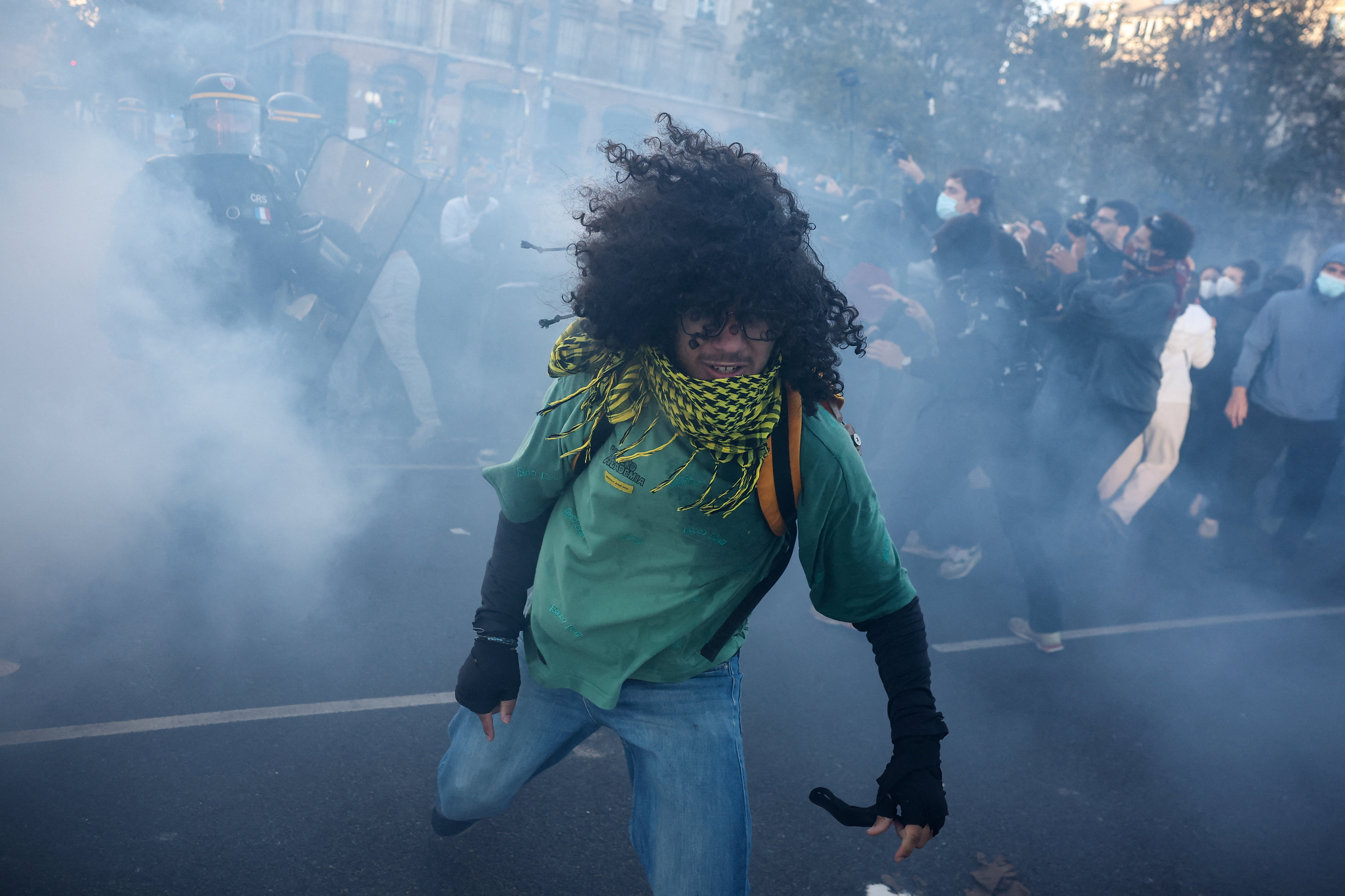 A protester amid tear gas during nationwide protests in Paris, France, October 8, 2026, to demand better school conditions. REUTERS/Pedro Nunes