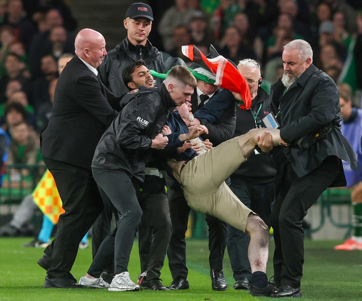 A pitch invader is removed during their UEFA Nations League, League B - Group 3, football match between Republic of Ireland and Austria