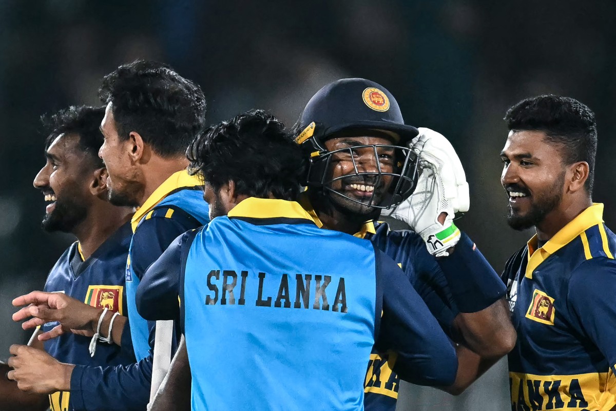 Sri Lanka's Janith Liyanage (2R) celebrates with teammates after his team's victory in the one-day international (ODI) tri-series cricket match between England and Sri Lanka at the Rawalpindi Cricket Stadium