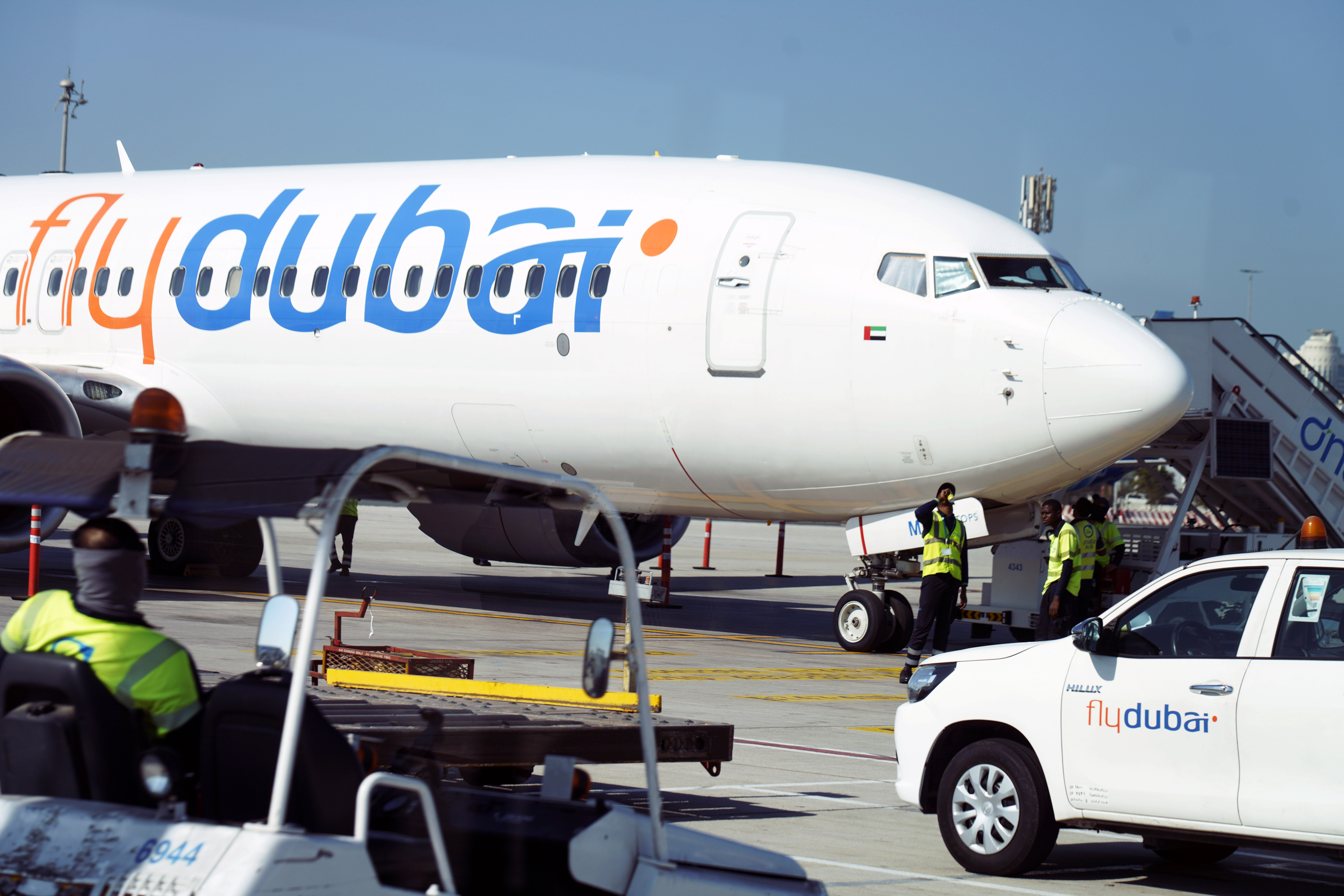 Workers prepare a FlyDubai flight at Dubai International Airport in Dubai, United Arab Emirates