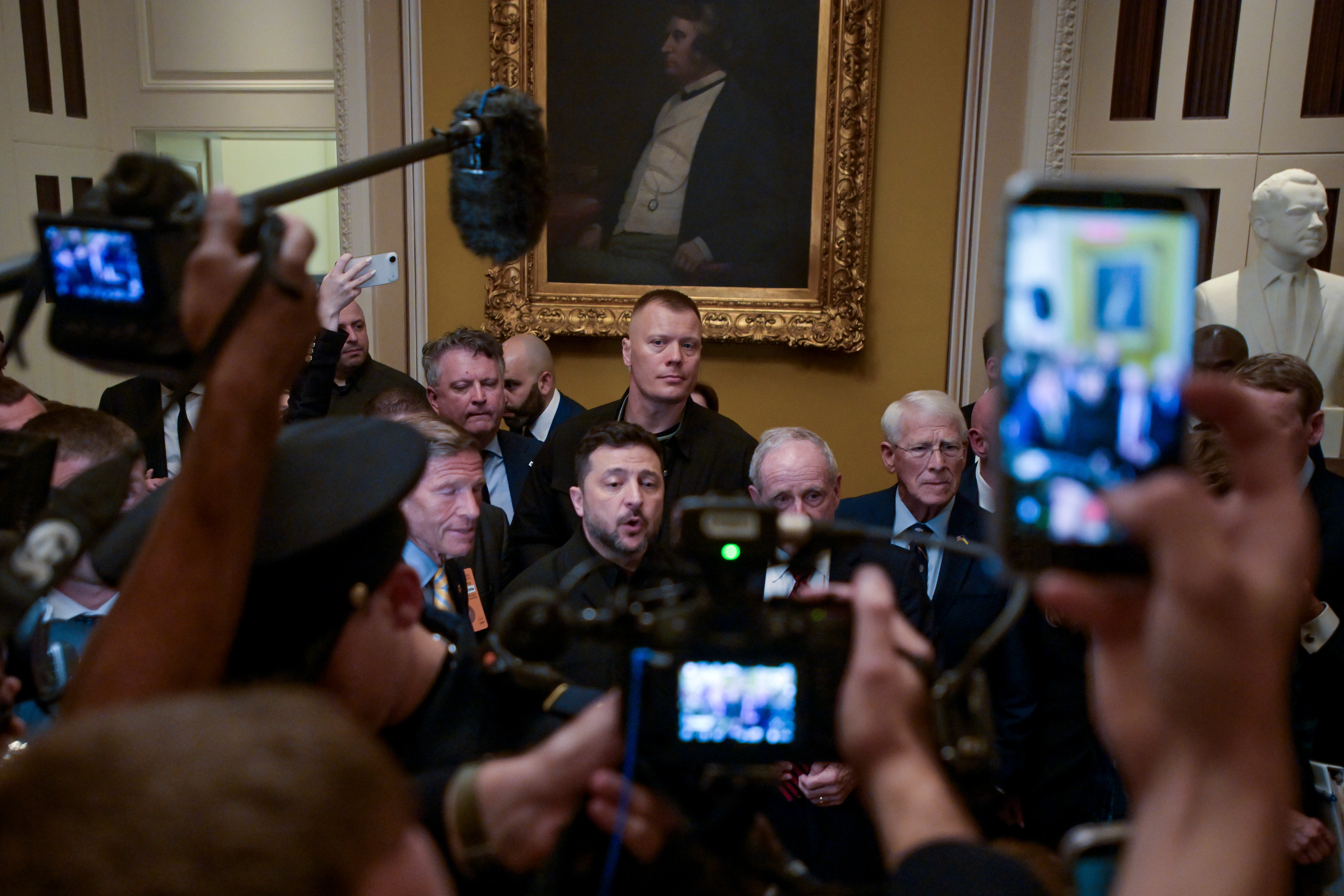 Ukraine's President Volodymyr Zelenskyy, center, speaks to reporters as leaves the U.S. Capitol with from left: Sen. Richard Blumenthal, D-Conn., Sen. James Risch, R-Idaho, and Sen. Roger Wicker, R-Miss., following a meeting of bipartisan leaders of the Lindsey O. Graham Sanctioning Russia and Iran Act of 2026, Tuesday, July 28, 2026, in Washington. (AP Photo/Rod Lamkey, Jr.)