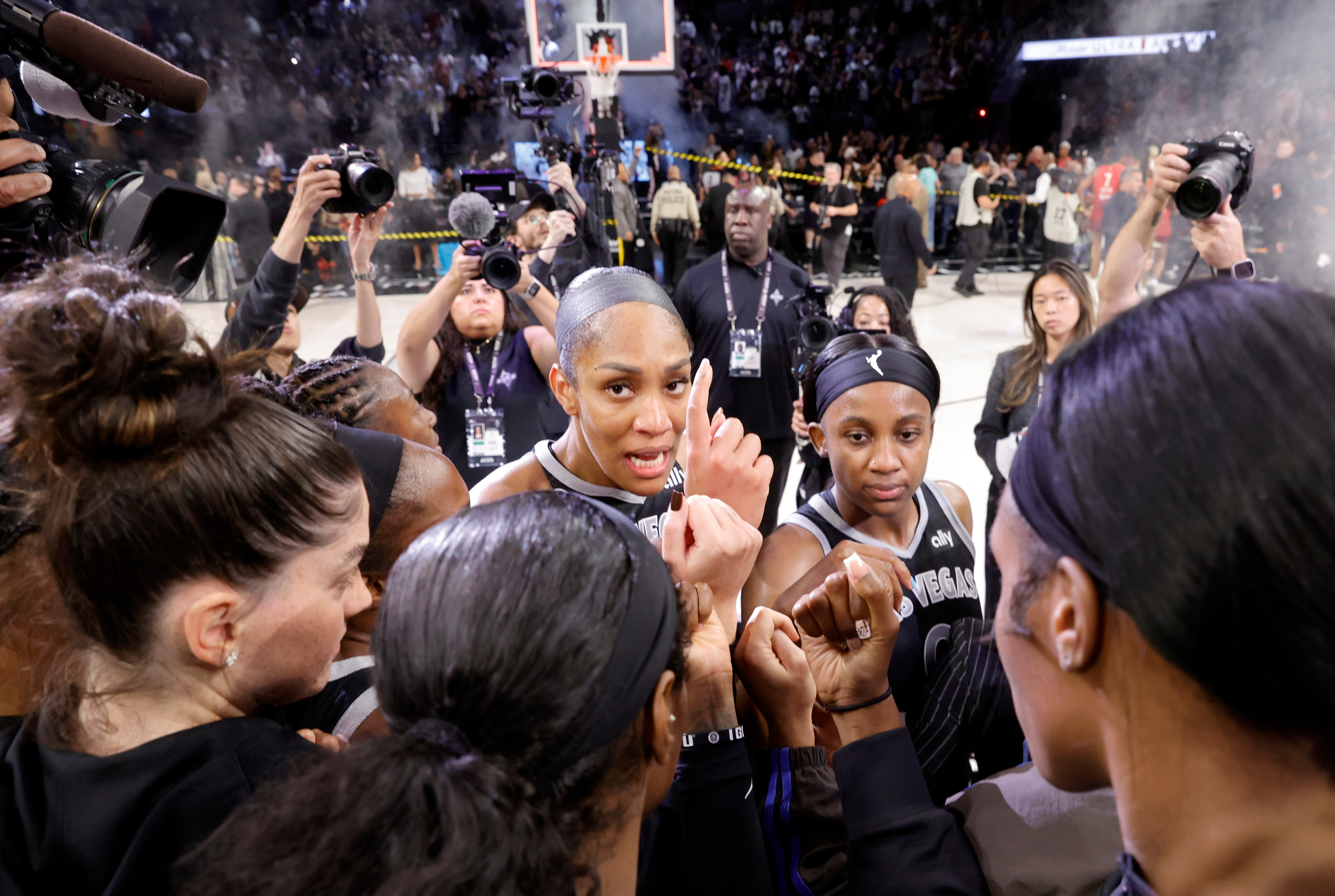 Las Vegas Aces center A'ja Wilson, center, huddles with teammates after the team defeated the Indiana Fever in Game 3 of an WNBA basketball first-round playoff series
