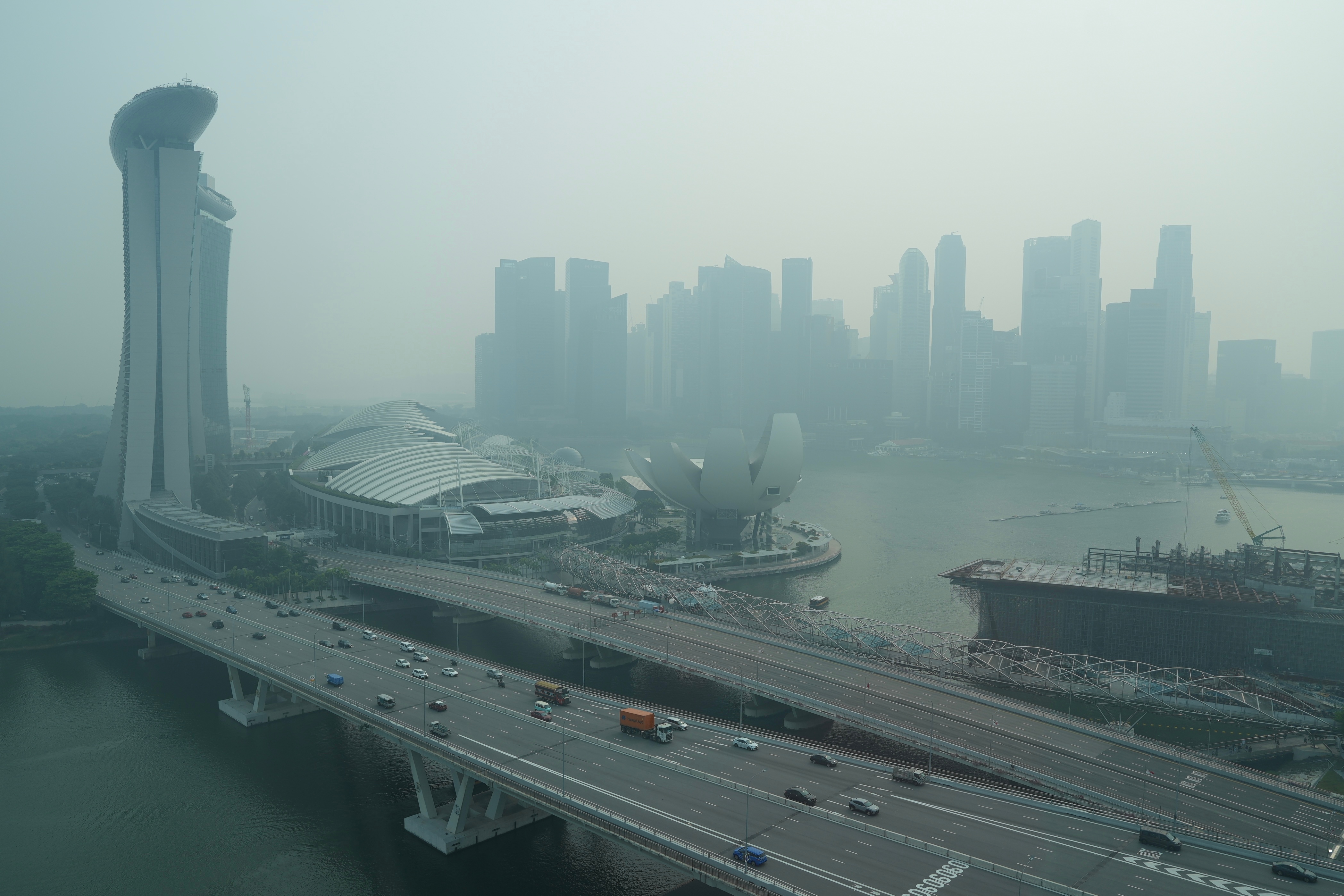 A thick haze obscures the skyline behind the Central Business District in Singapore, on October 9, 2026