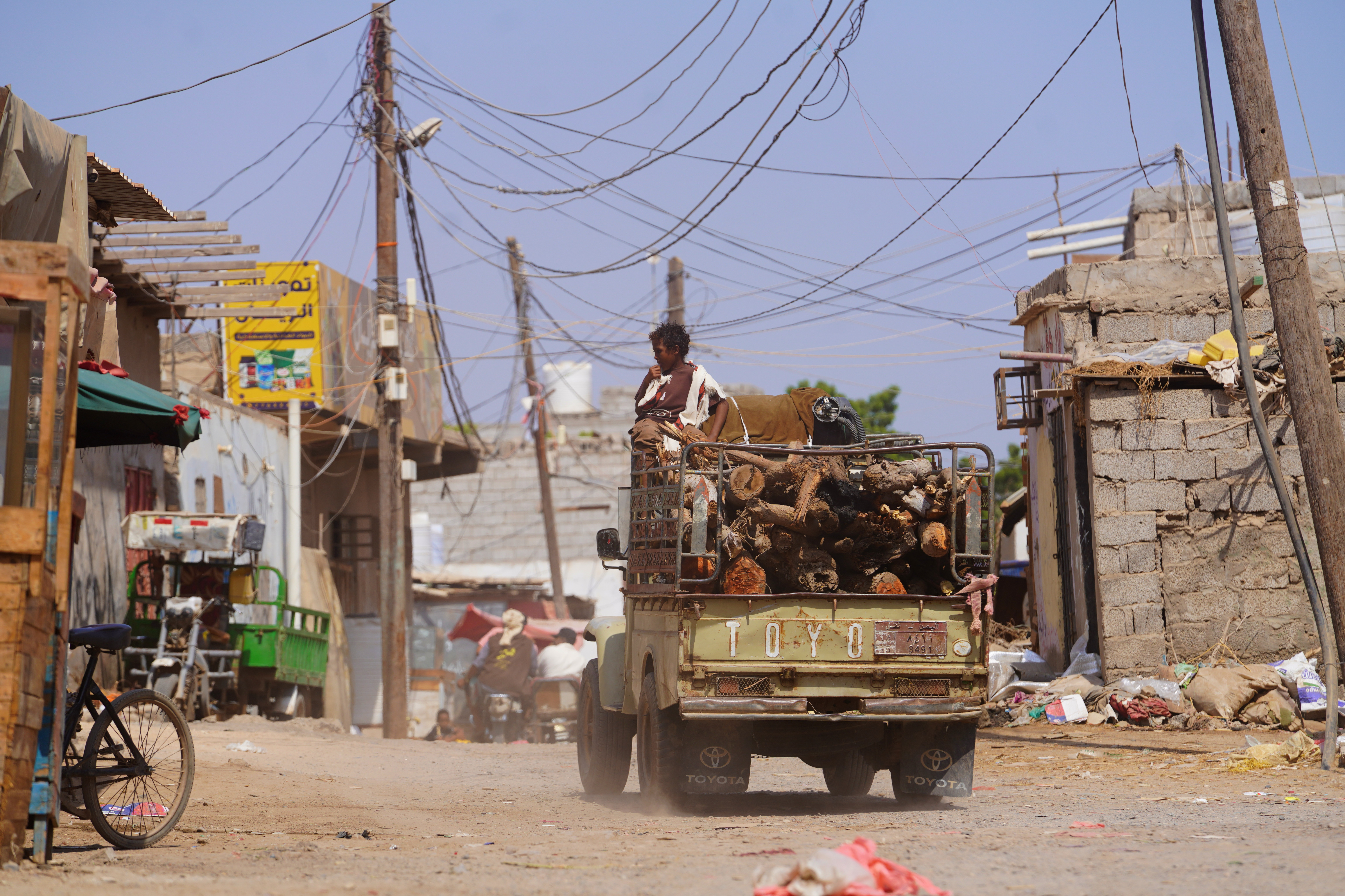 A truck loaded with firewood drives in Aden, Yemen