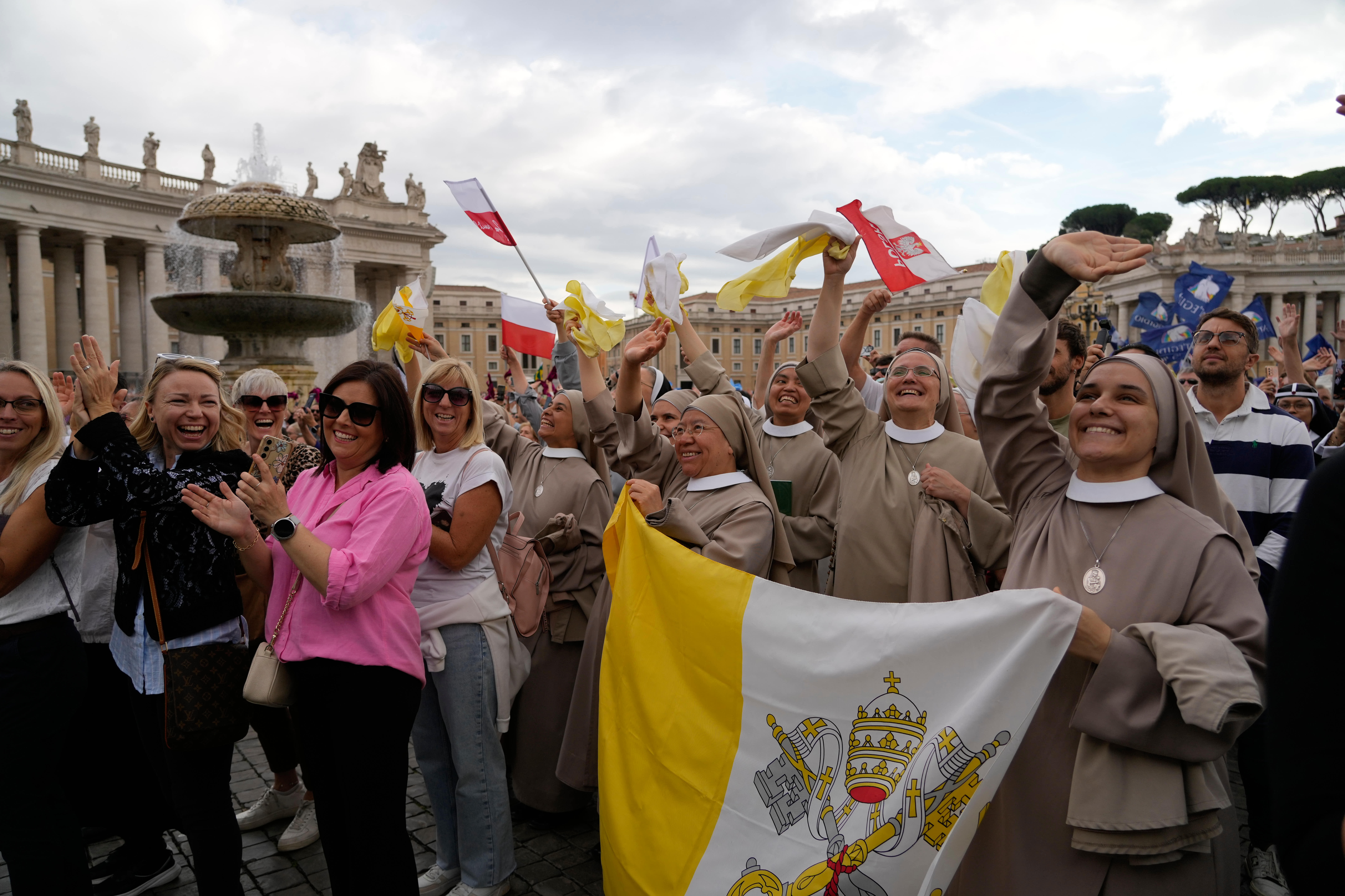 Faithful watch Pope Leo XIV appearing at the window of his study in the Apostolic Palace overlooking Saint Peter's Square at the Vatican for the traditional noon blessing after praying the Angelus, Sunday, October 18, 2026, a day after he returned from the hospital, where he had lung cancer removed on Tuesday [Gregorio Borgia/AP]