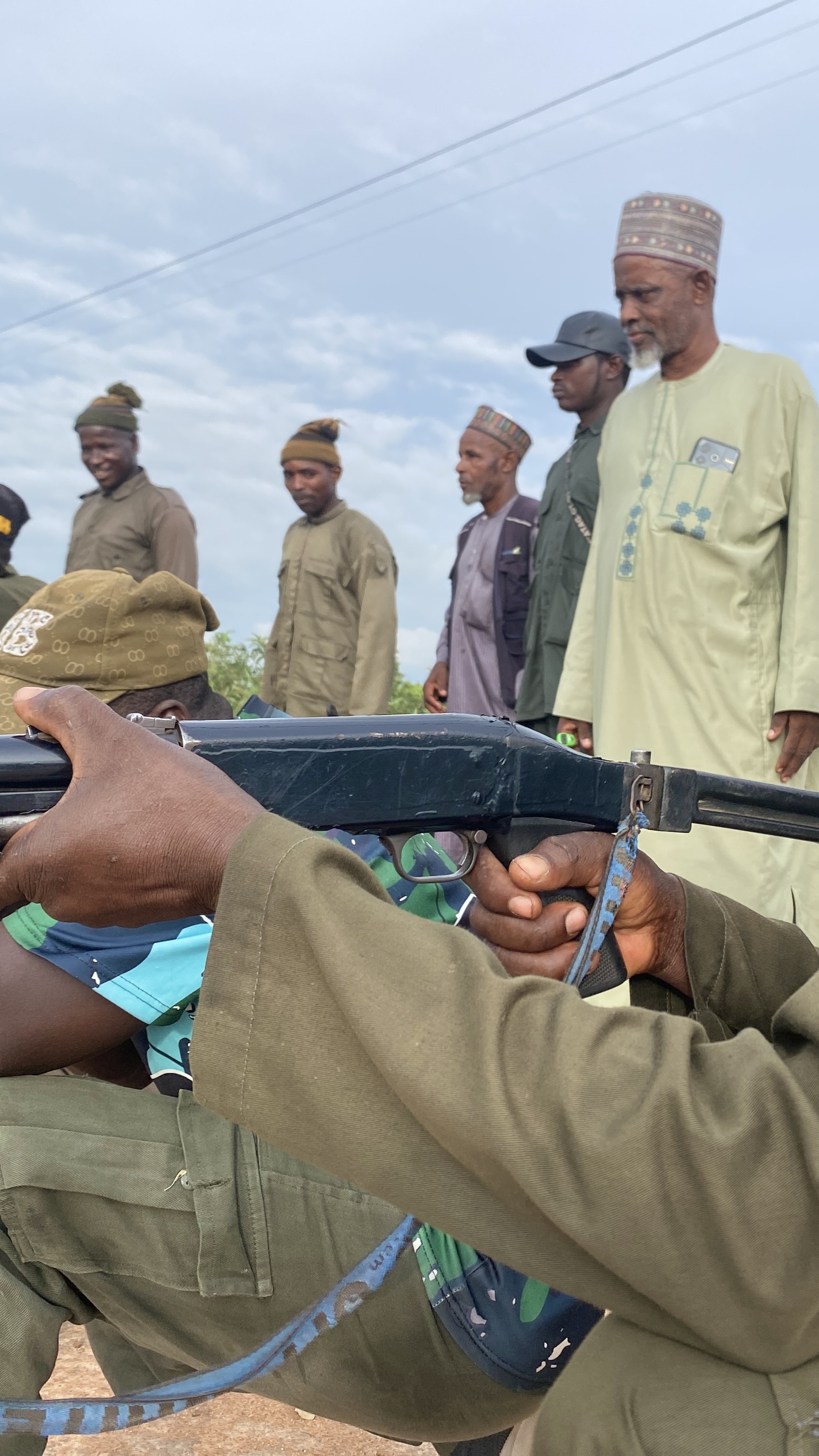 Pulaku commander Musa Usman Malkohi stands behind members of the vigilante group during a training drill in Adamawa State, Nigeria.