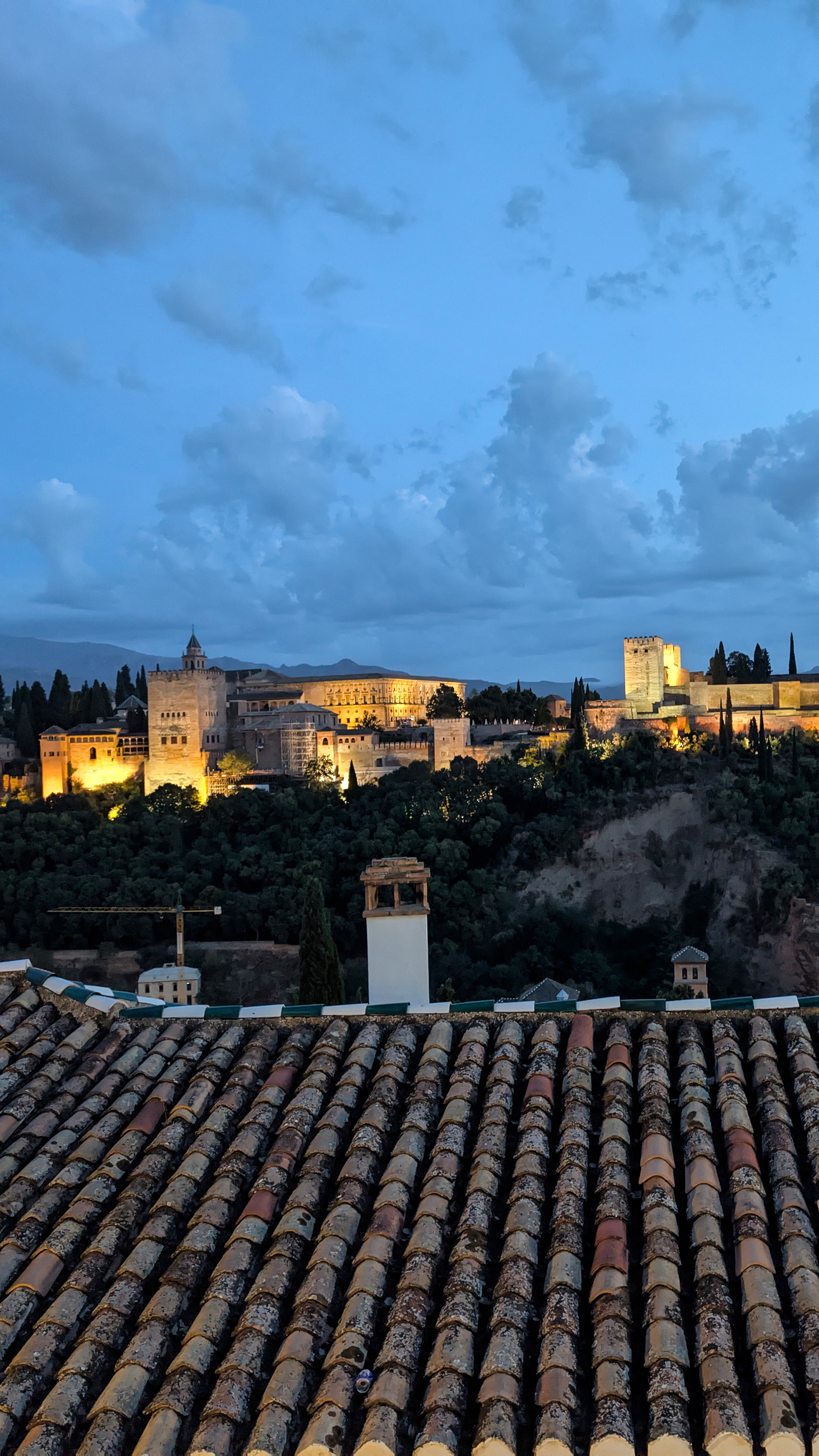 Across the valley the Alhambra glows against the evening sky in Granada