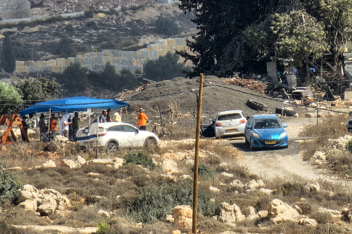 Israeli settlers posted outside the Abayat home in Umm Safa, northwest of Ramallah, occupied West Bank [Al Jazeera]