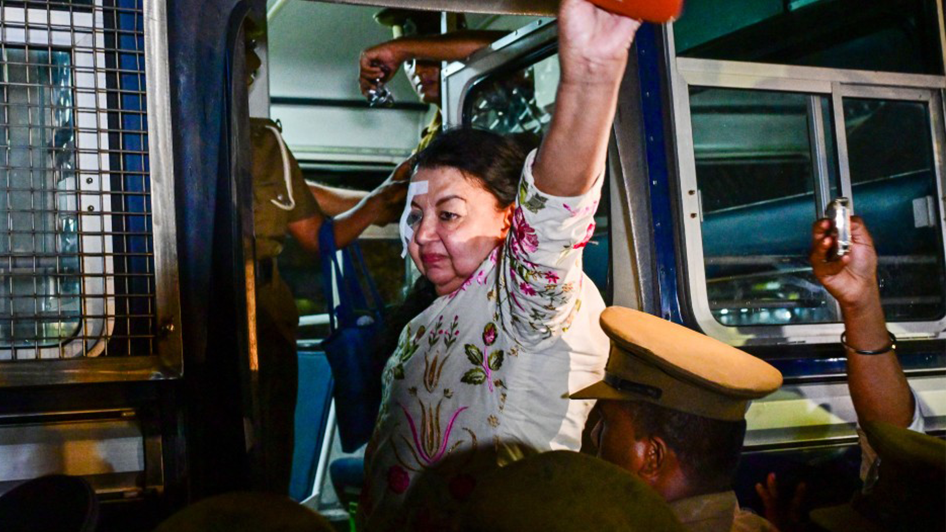 Prison officers escort former First Lady Shiranthi Rajapaksa, wife of Sri Lanka's former President Mahinda Rajapaksa, to prison after being arrested in Colombo on October 7, 2026.