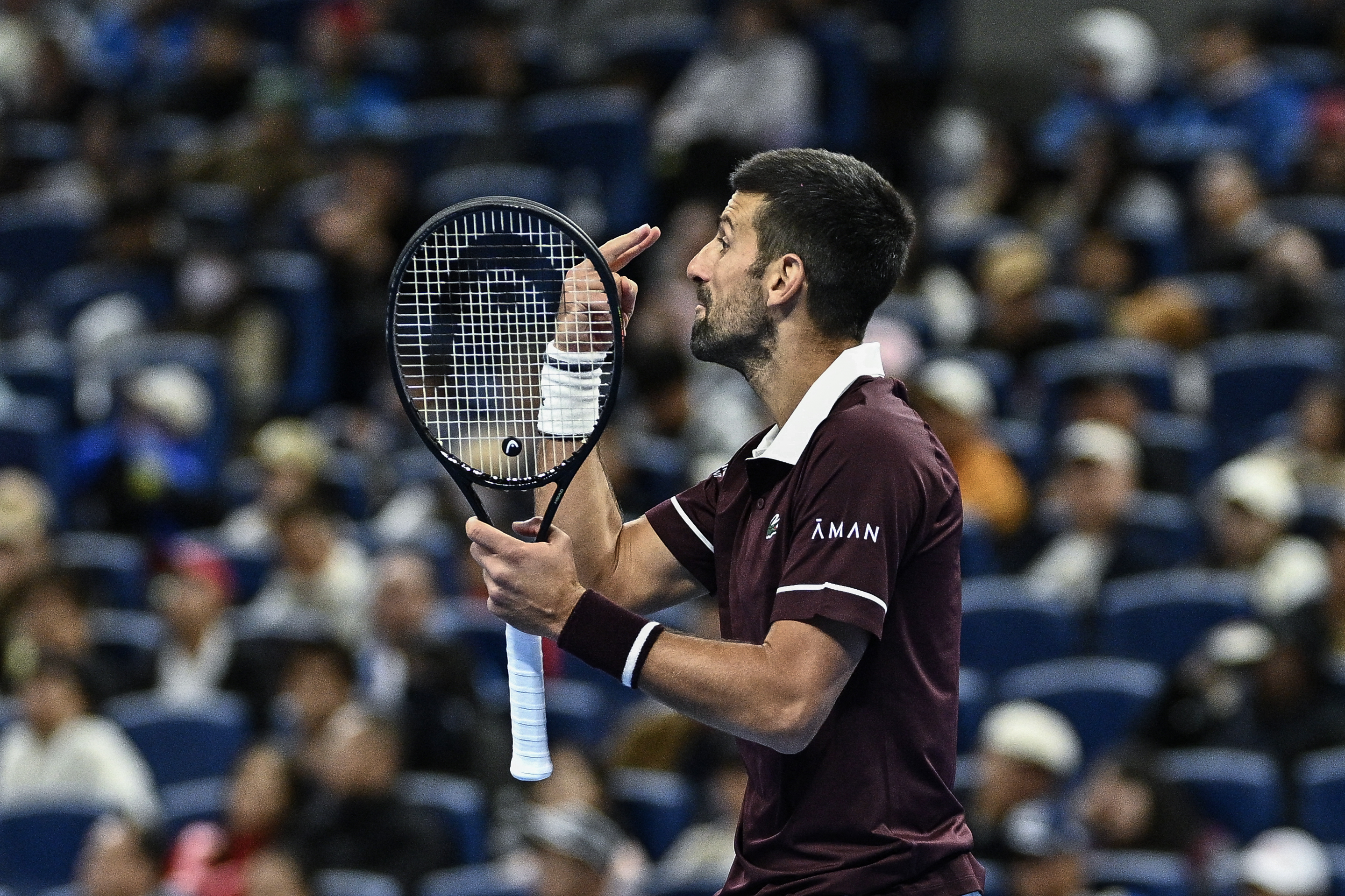 Serbia's Novak Djokovic reacts during his men’s singles quarter-final match against Germany’s Alexander Zverev at the China Open tennis tournament in Beijing on October 4, 2026.