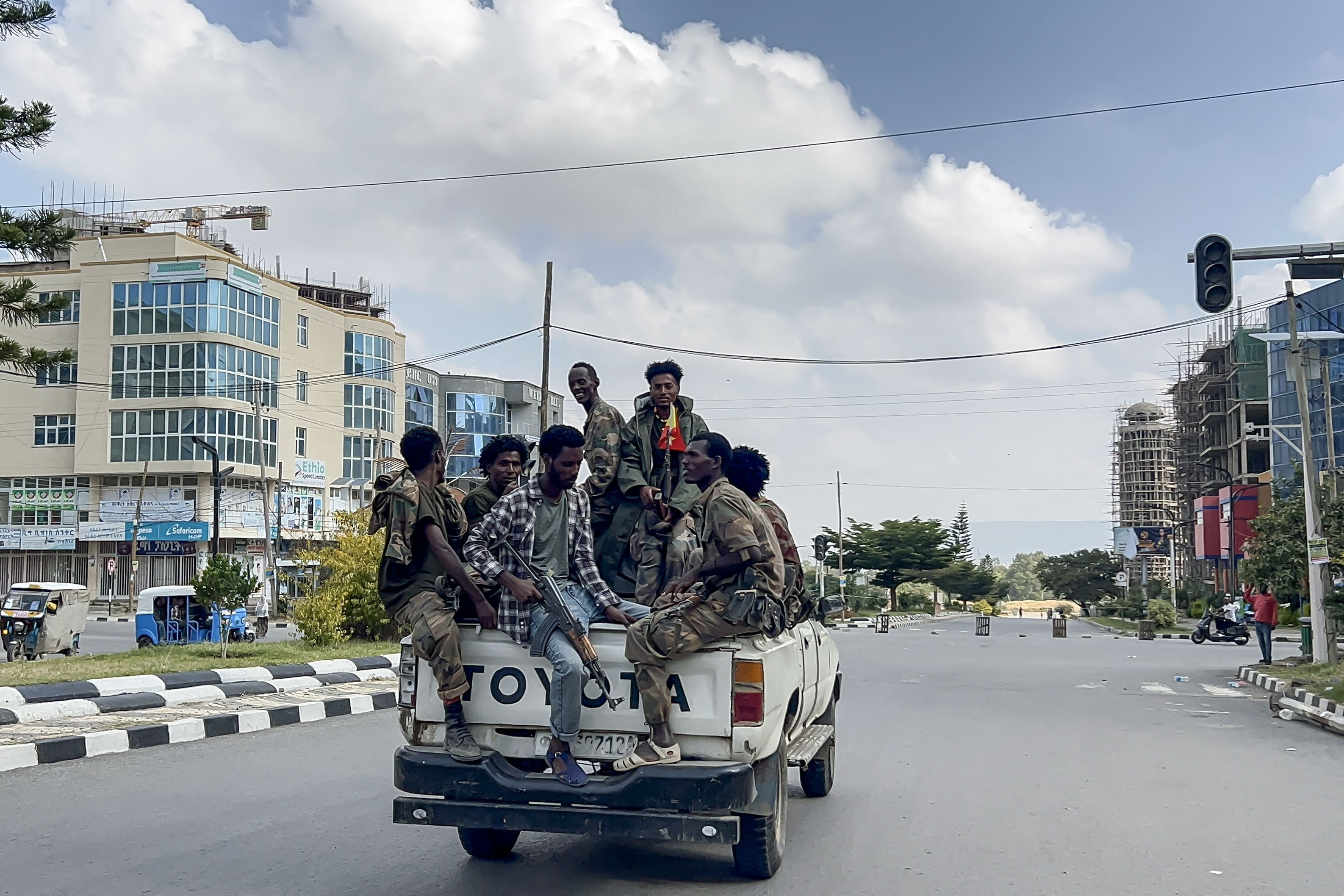Members of the Ethiopian pro-government Tigray Peace Force (TPF) ride in a pickup truck while Ethiopian federal and allied forces enter the Tigray capital of Mekelle, October 4, 2026 [AFP]