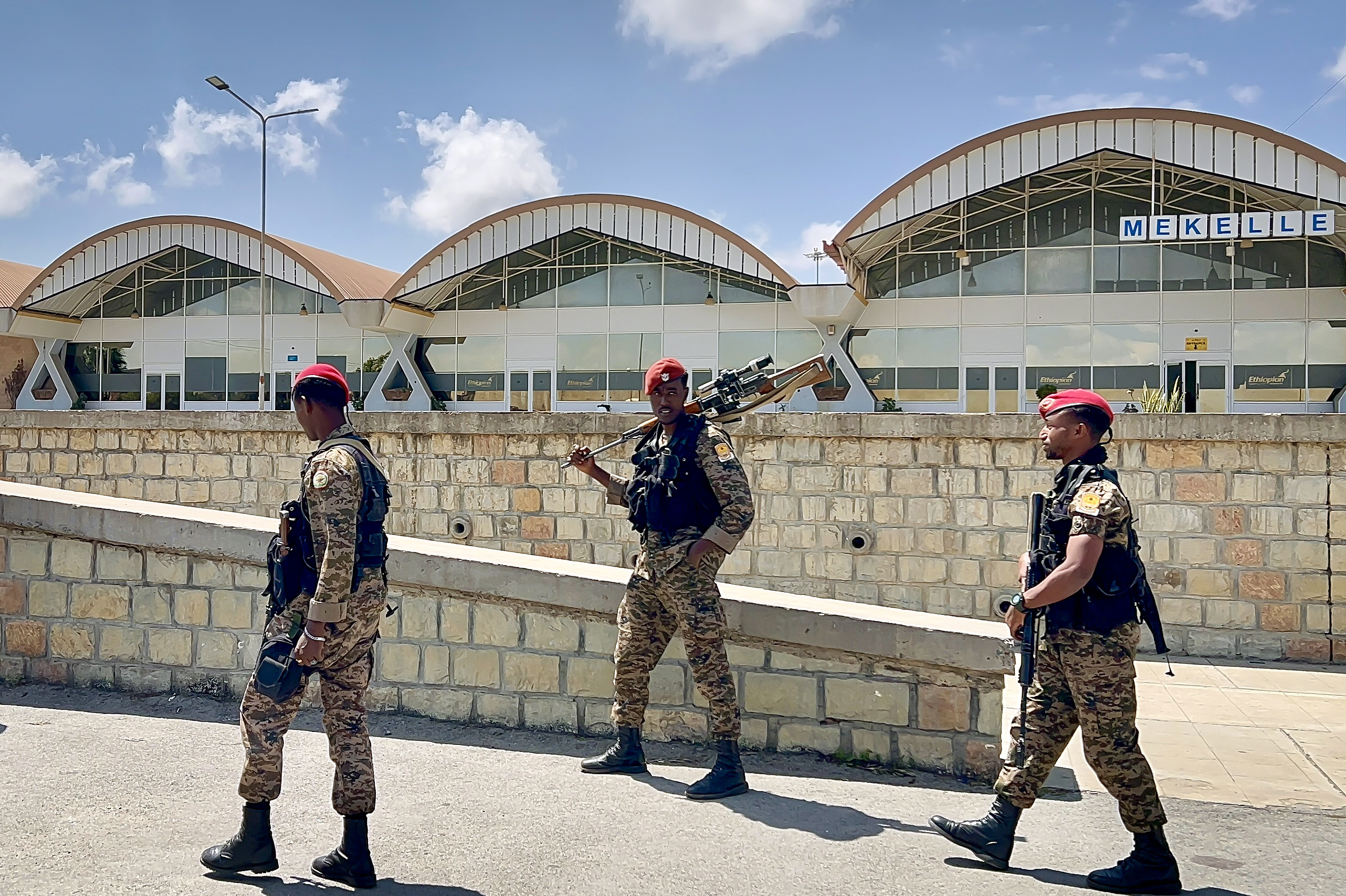 TOPSHOT - Members of the Ethiopian National Defense Force (ENDF) gather in front of Mekelle Alula Aba Nega International Airport after federal forces retook control of the facility in Mekelle on October 6, 2026.
