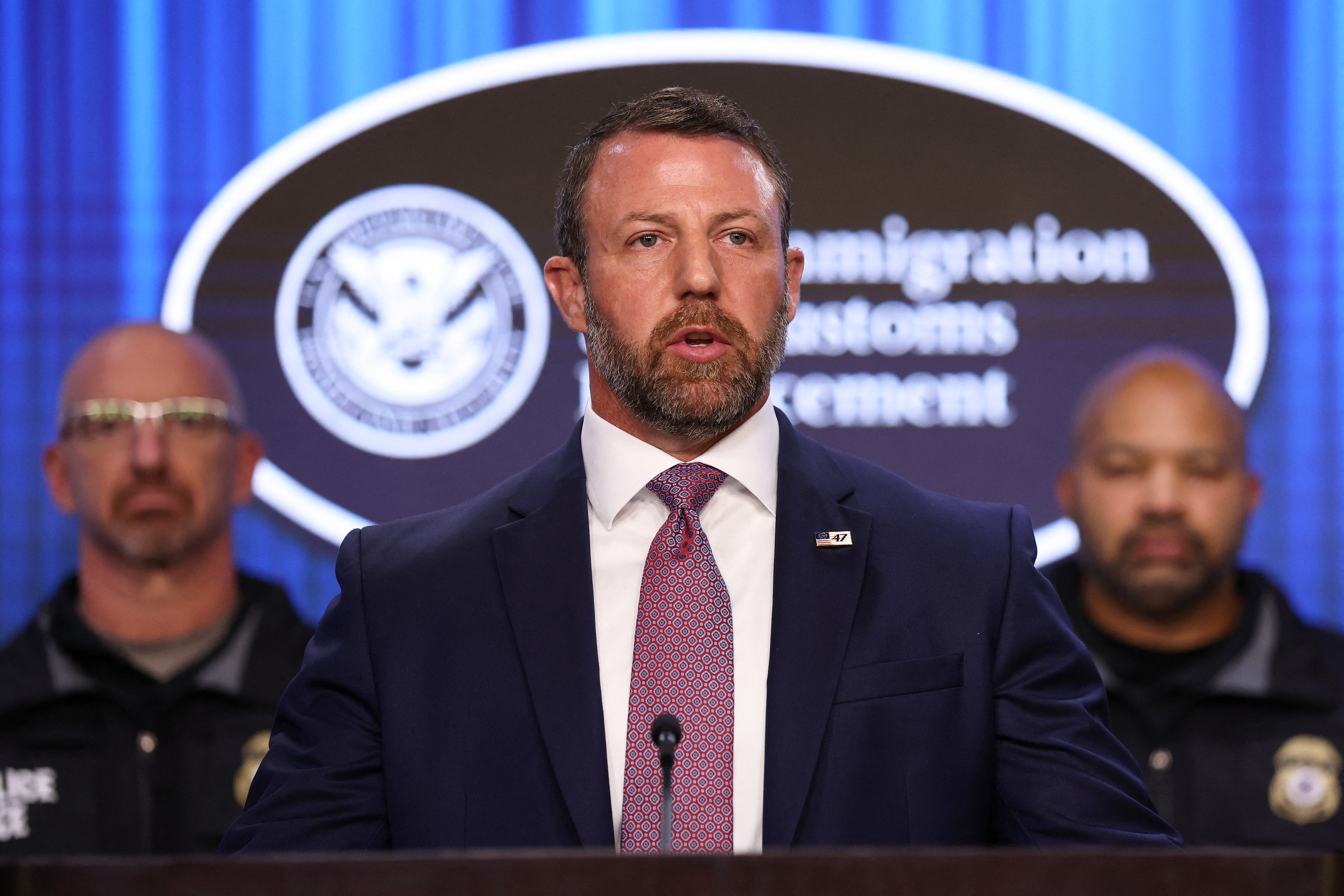 WASHINGTON, DC - OCTOBER 09: U.S. Secretary of Homeland Security Markwayne Mullin (C) speaks during a press conference at U.S. Immigration and Customs Enforcement (ICE) headquarters on October 09, 2026 in Washington, DC. Secretary Mullin, joined by ICE officials, addressed yesterday's shooting of a man in New York City by a federal immigration agent as he spoke out against sanctuary city policies. Kevin Dietsch/Getty Images/AFP (Photo by Kevin Dietsch / GETTY IMAGES NORTH AMERICA / Getty Images via AFP)