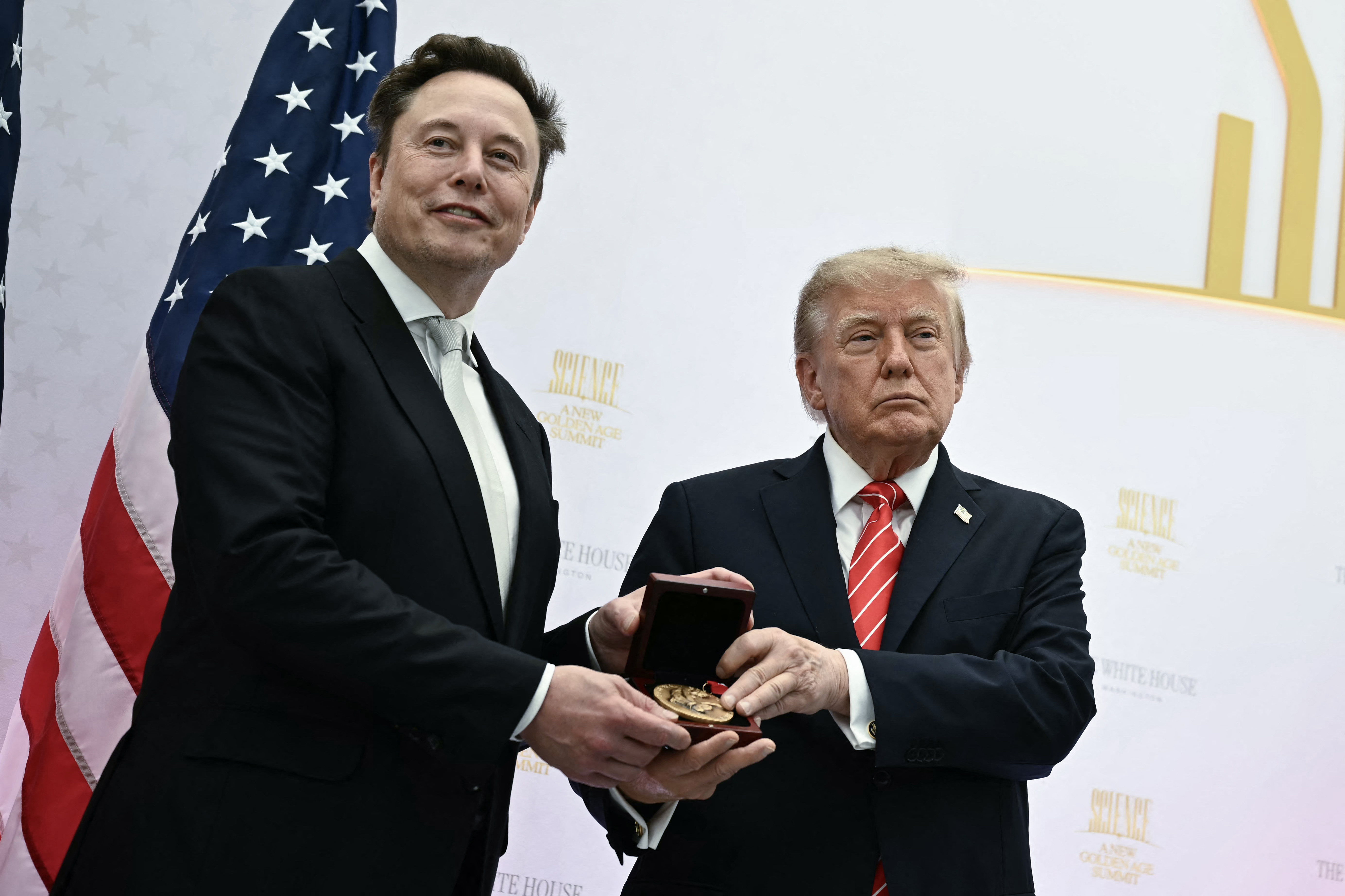 (FILES) US President Donald Trump presents the National Medal of Science to Elon Musk during the "Golden Age of American Innovation Summit" at the Institute of Peace in Washington, DC, on October 8, 2026.