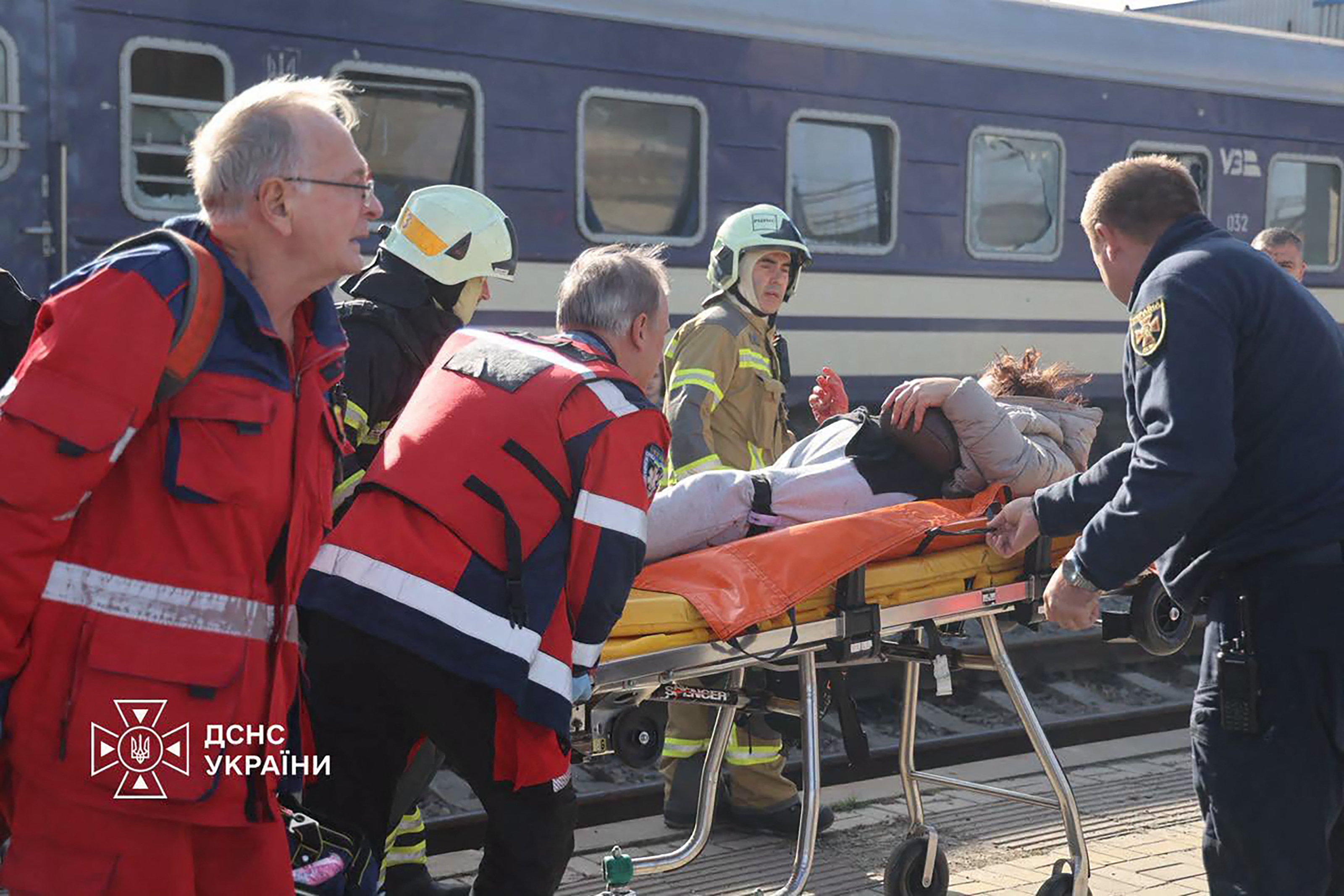 Ukrainian rescuers carry an injured person in Dnipro