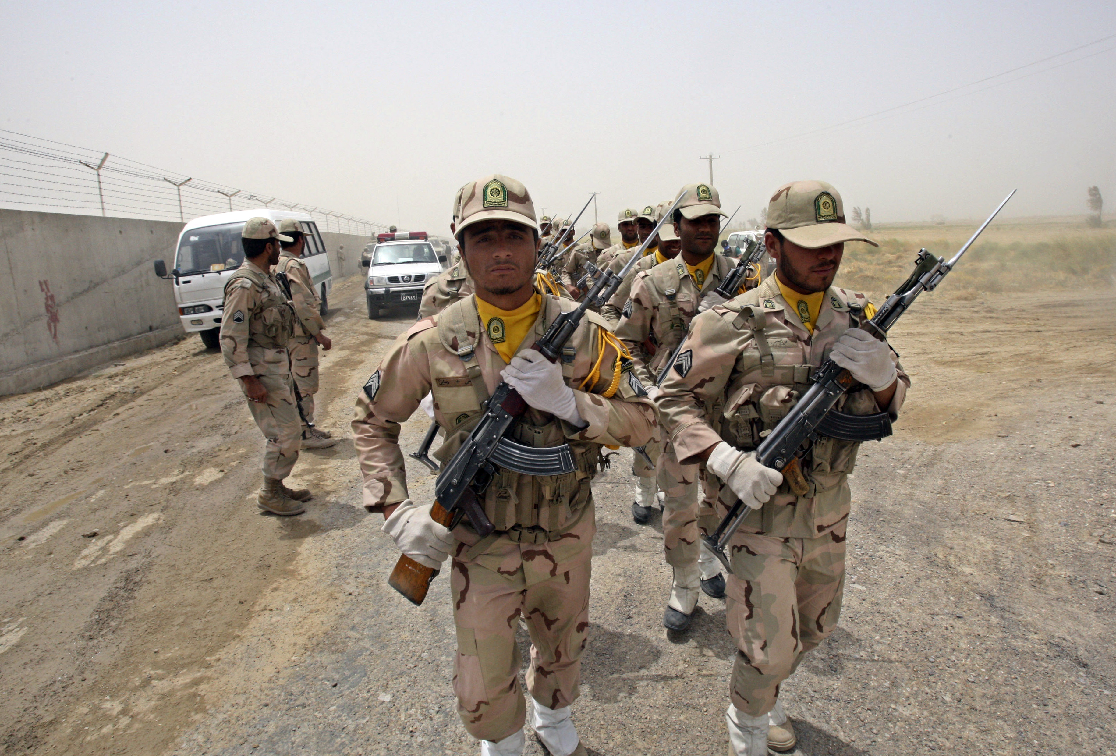 FILE-- In this Tuesday, July 19, 2011 file photo, a group of Iranian border guards march at the eastern border of Iran shared with Pakistan and Afghanistan near Zabol, Sistan and Baluchestan Province, Iran. Iran's state TV says the military has dismissed several commanders from service and others face court proceedings for alleged negligence after the abduction of five Iranian border guards by Pakistan-based militants on Feb. 6, 2014. The five were abducted in Iran's Sistan and Baluchestan province and reportedly taken to Pakistan. Iran has said it sent officials to Pakistan to coordinate their release. (AP Photo/Vahid Salemi, File)