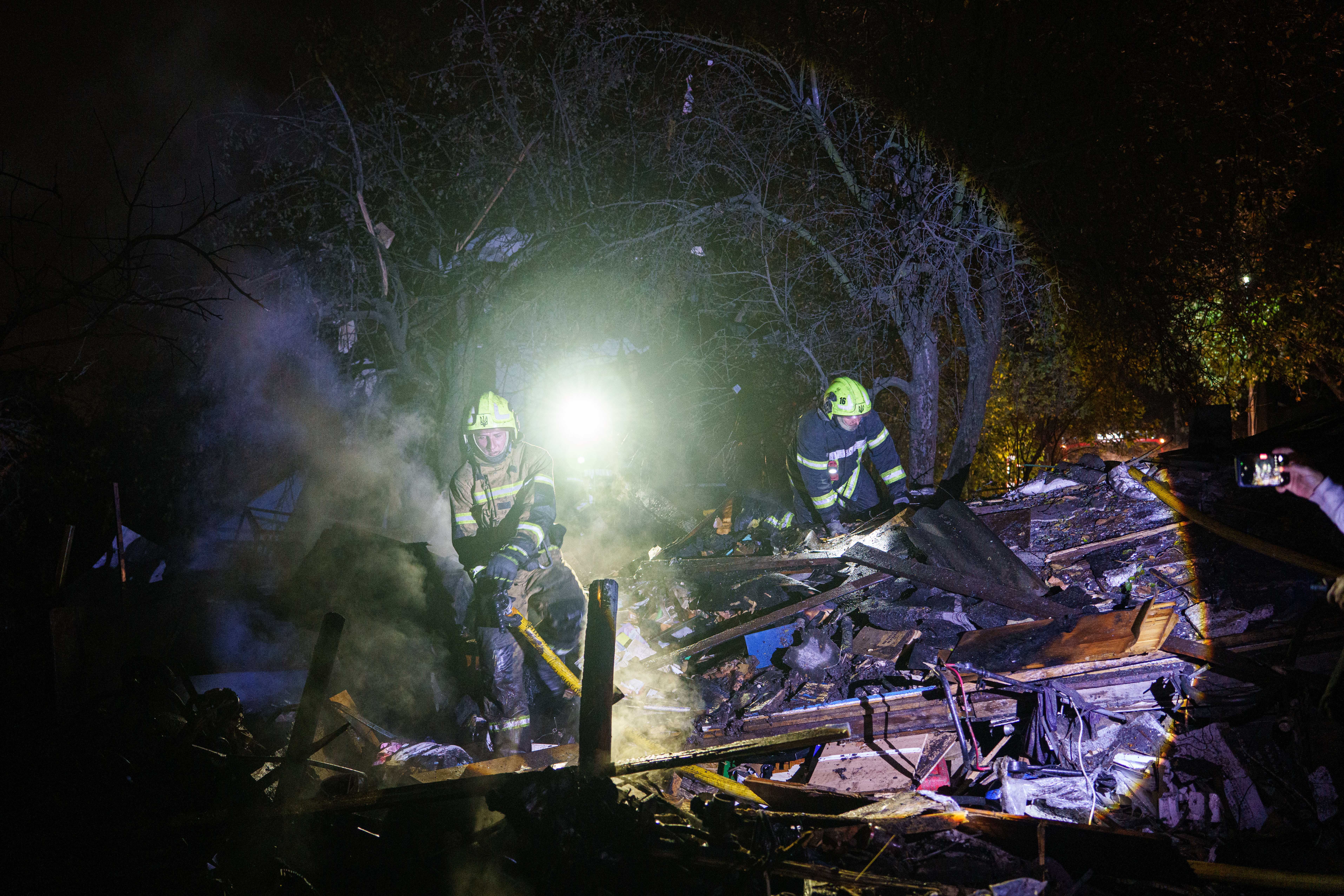 Rescue workers put out a fire at a residential house destroyed in a Russian missile strike on Kyiv, Ukraine, Wednesday, Oct. 21, 2026. (AP Photo/Evgeniy Maloletka)