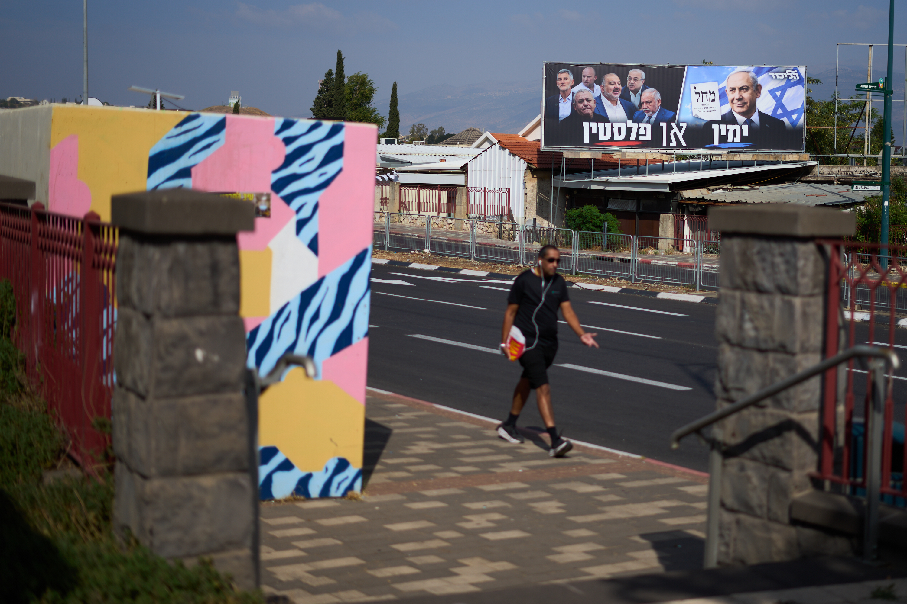 An election campaign billboard featuring Israeli Prime Minister Benjamin Netanyahu, leader of the Likud party, and other politicians hangs in Kiryat Shmona, Israel's largest northern city, near Lebanon's border, ahead of the country's general election, Tuesday, Oct. 13, 2026. The Hebrew writing reads, "Right or Palestine." (AP Photo/Ariel Schalit)
