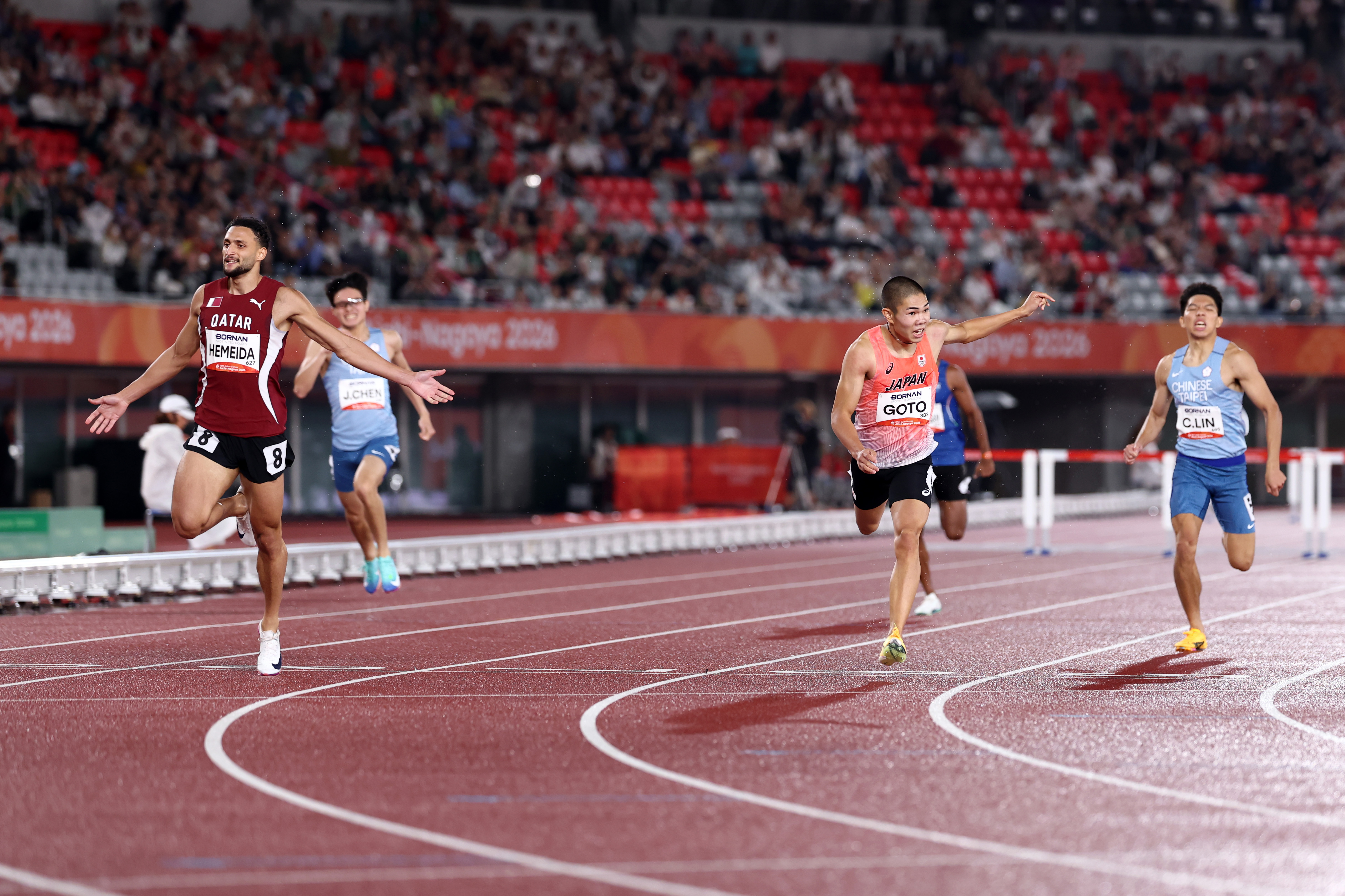 NAGOYA, JAPAN - SEPTEMBER 28: Bassem Hemeida of Qatar crosses the finish line ahead of Taiju Goto of Japan to win the gold medal in the Athletics Men's 400m Hurdles Final on day nine of the 20th Asian Games Aichi-Nagoya at Nagoya City Mizuho Park Athletic Stadium on September 28, 2026 in Nagoya, Aichi, Japan. (Photo by Yong Teck Lim/Getty Images)