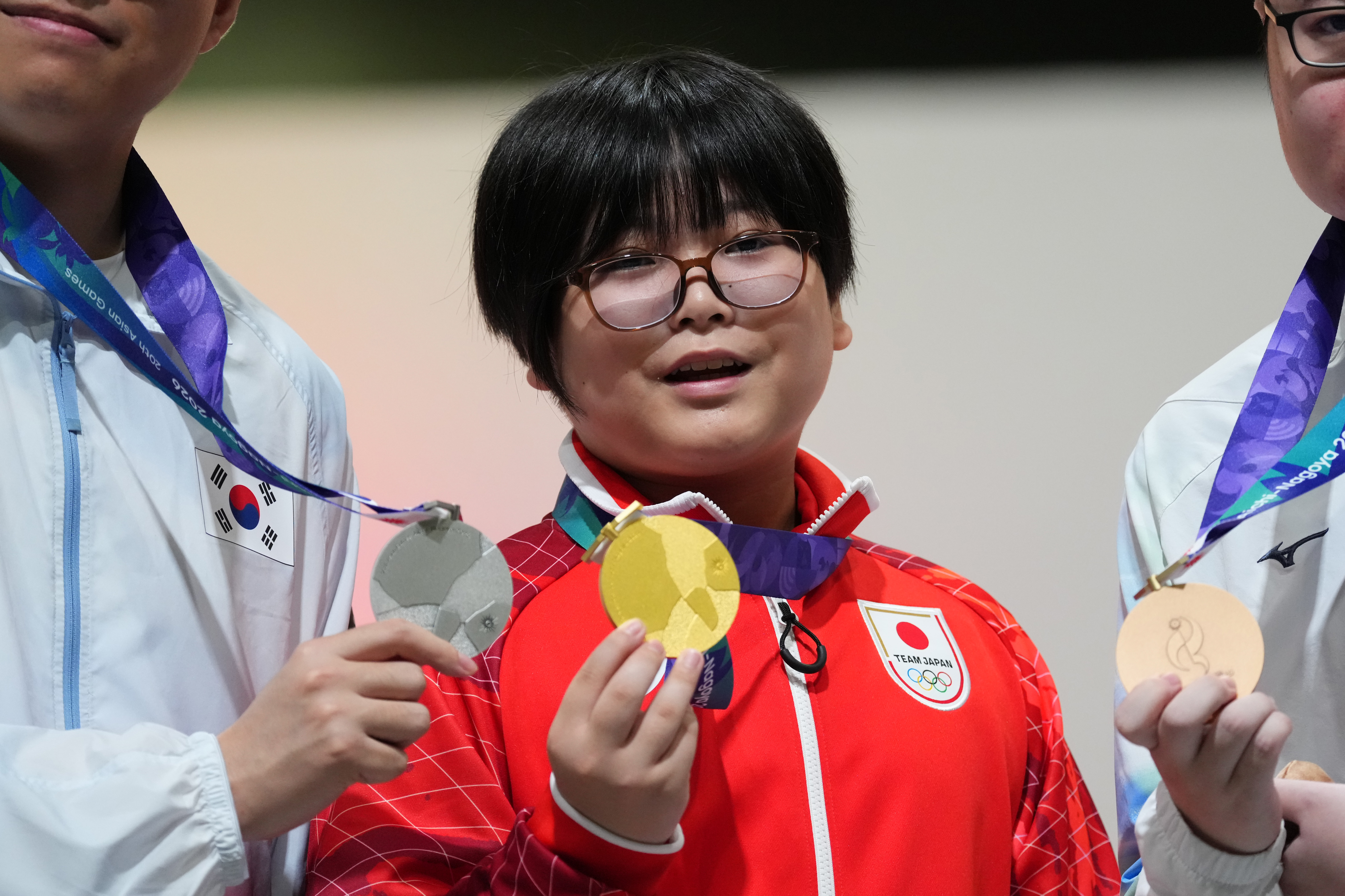 TOKONAME, JAPAN - SEPTEMBER 26: Gold medalist Yuki Kurihara of Japan poses on the podium at the medal ceremony for the Esports Puzzle [Puyo Puyo Champions] on day seven of the 20th Asian Games Aichi-Nagoya at Aichi Sky Expo on September 26, 2026 in Tokoname, Aichi, Japan. Kurihara becomes the youngest gold medalist at the Asian Games at the age of 11. (Photo by Toru Hanai/Getty Images)