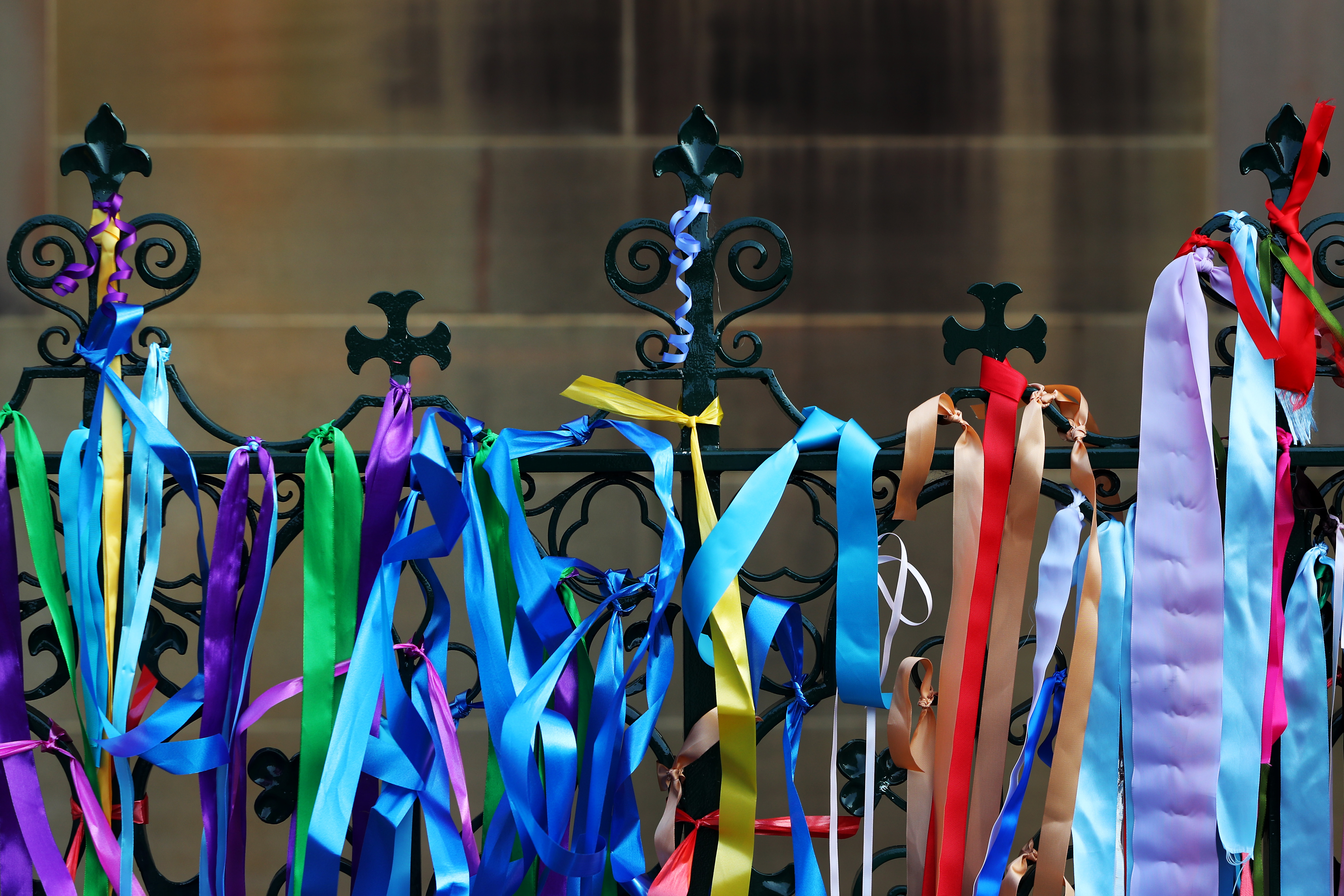 SYDNEY, AUSTRALIA - FEBRUARY 01: Ribbons in support of abuse survivors are seen tied to the fence of St Mary’s Cathedral ahead of Cardinal George Pell’s pontifical requiem mass on February 01, 2023 in Sydney, Australia. Cardinal George Pell, a former senior Catholic Church official who was accused of sexual violence in Australia and then cleared, died on 10 January 2023 aged 81 years old. His body was returned to Sydney after his funeral at the Vatican and will lie in state at St. Mary's cathedral on Feb. 1 and 2. (Photo by Lisa Maree Williams/Getty Images)