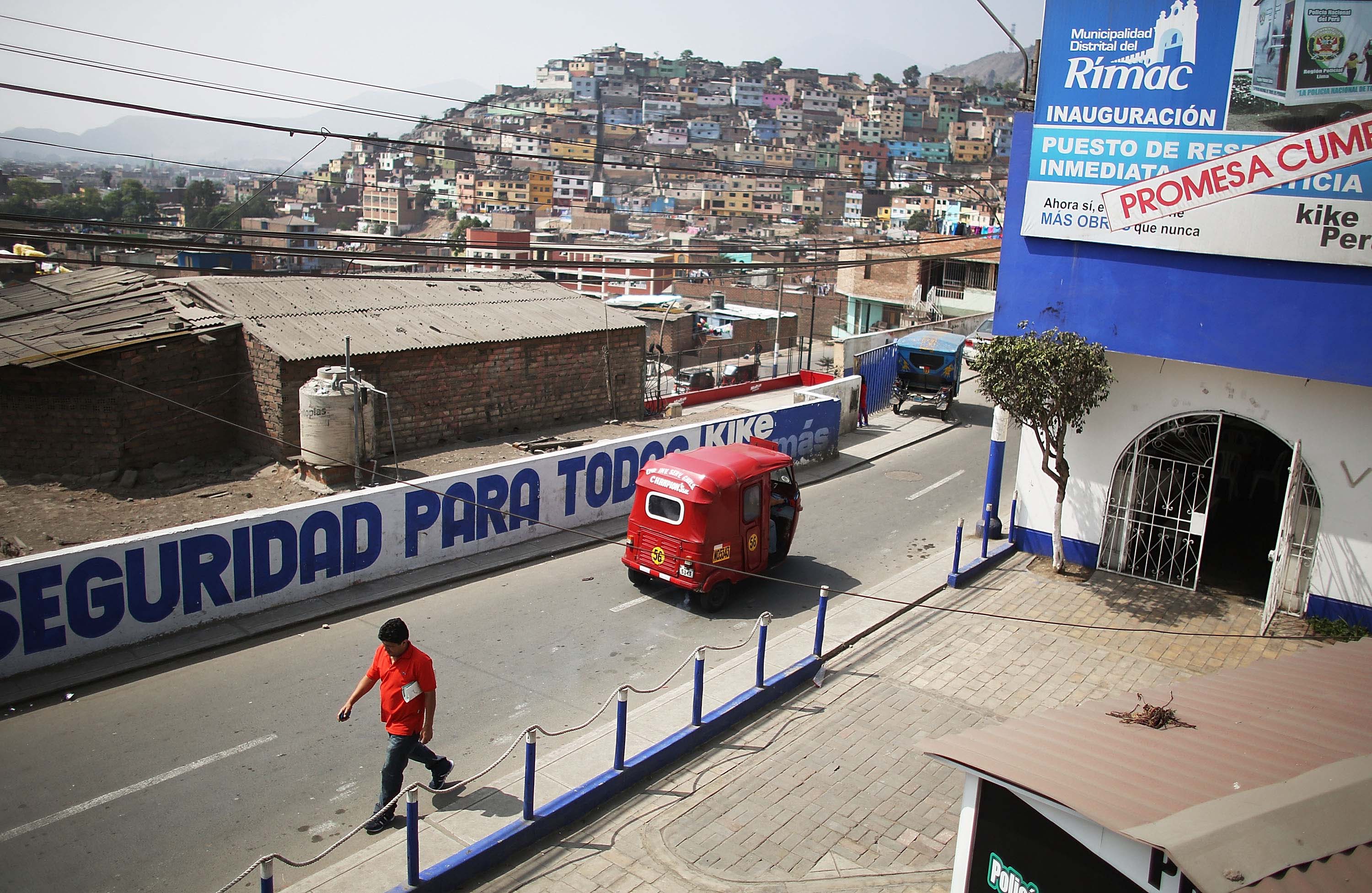 A man walks along a street in Lima, Peru