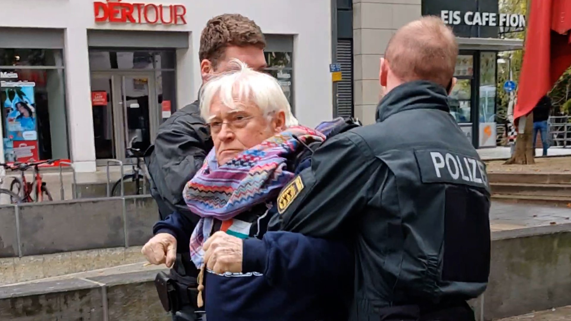 Elderly protester being detained by police in Germany
